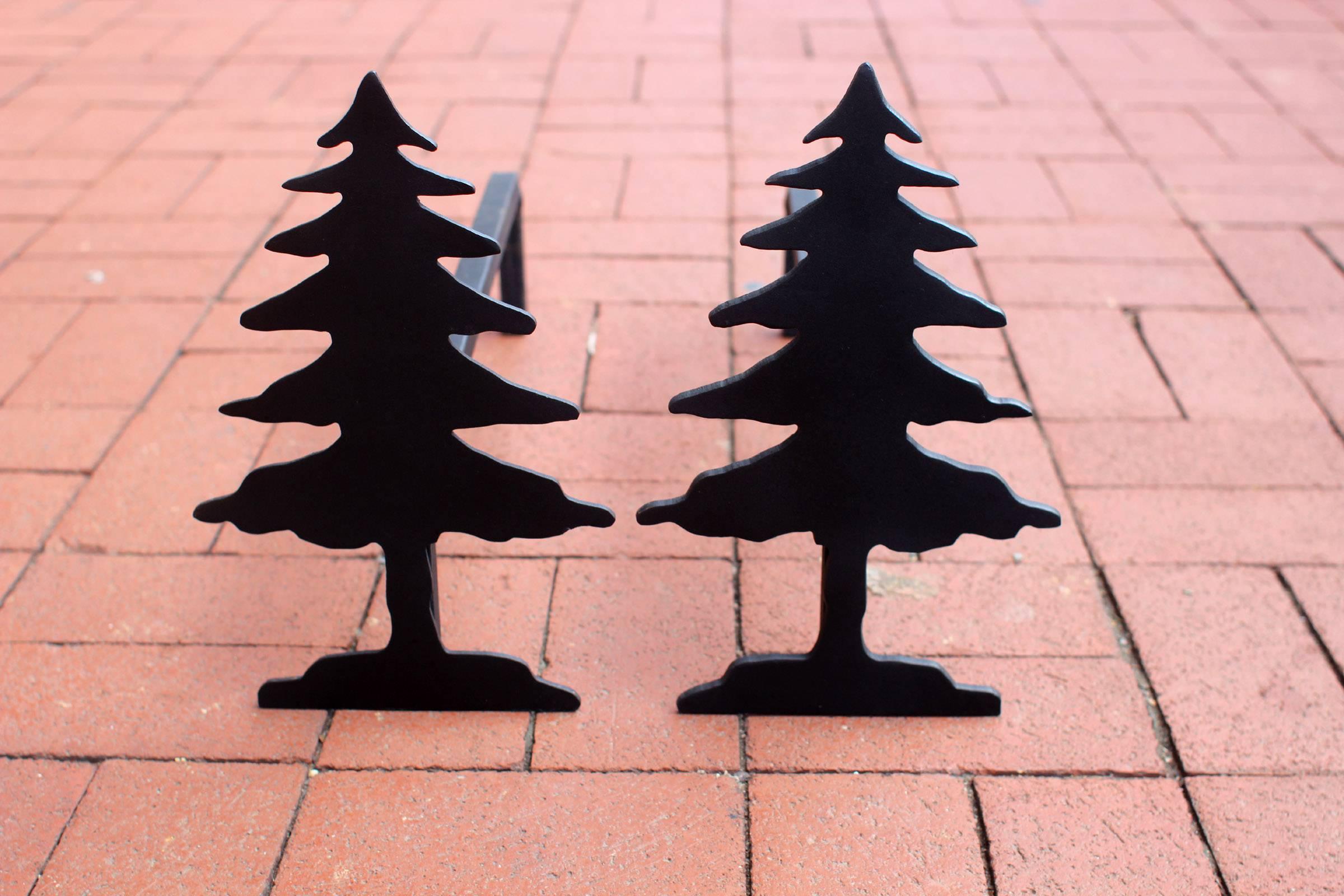 Very good cast iron fireplace andirons in the form of silhouetted pine trees. Black paint finish.
