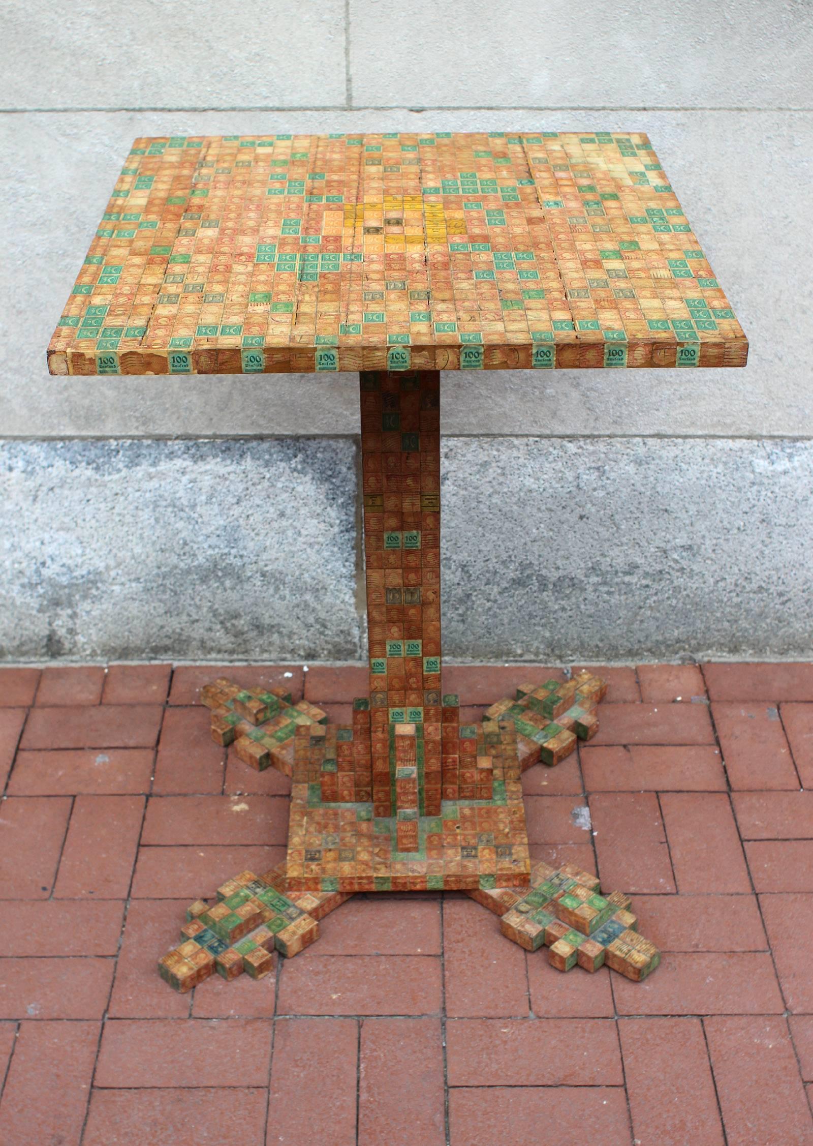 Center table fully decorated with cancelled stamps. The design of the table was such that the dimensions of every part of it are determined by the height and width of a postage stamp and every inch was covered by full stamps. American, probably