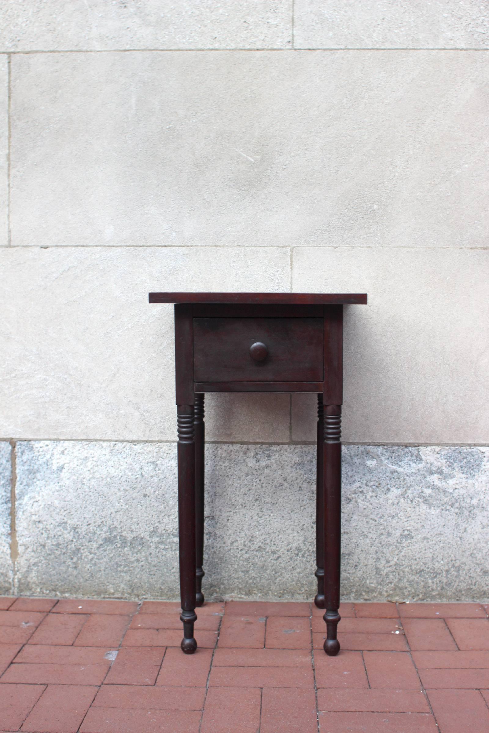 Nicely proportioned cherry table with good lines in dark stain, molding that creates a tray top, one drawer with both front and back dovetailed, turned knob and legs; American, circa 1840.