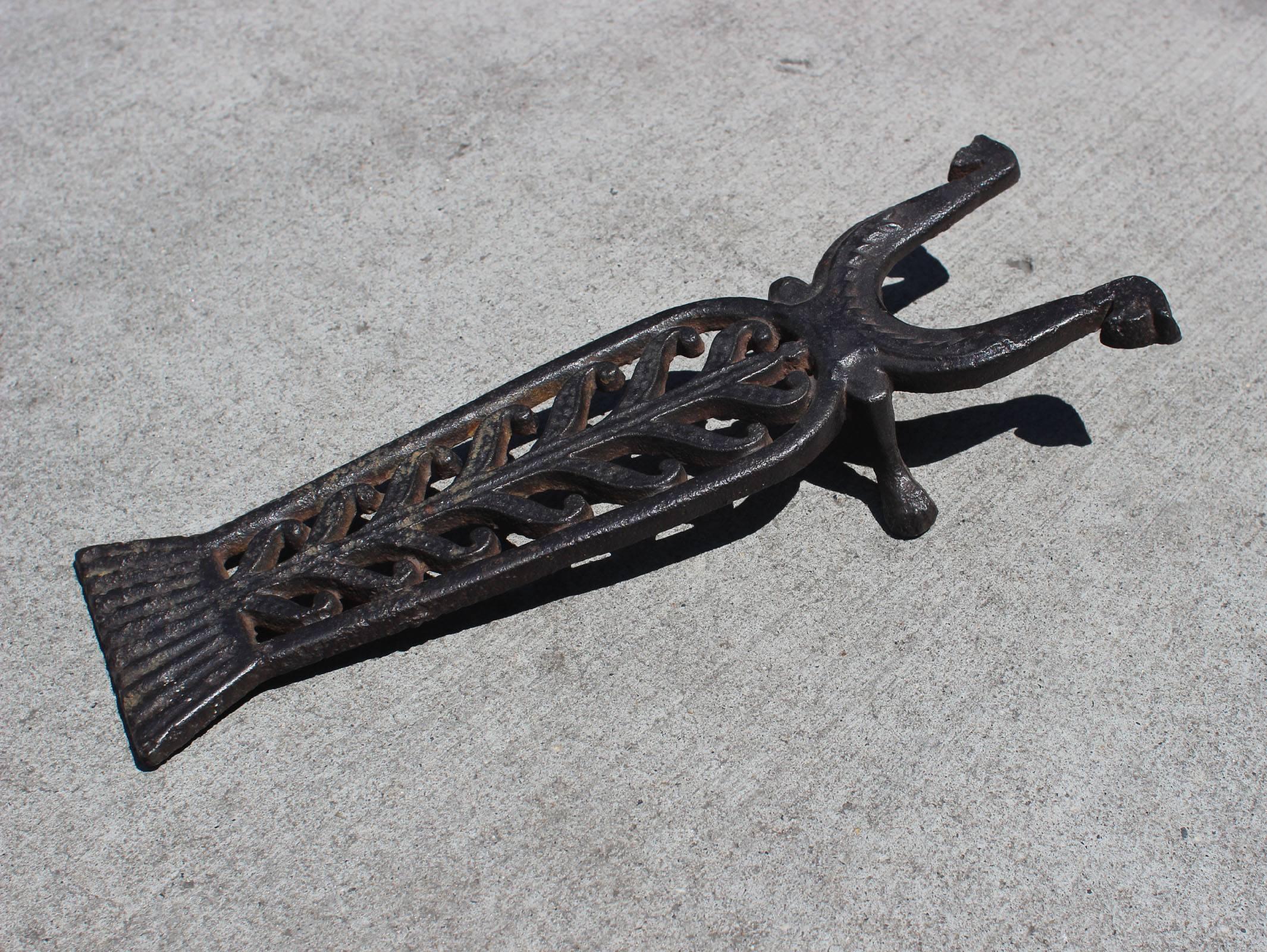 Handsome and heavy cast iron boot jack with nice detail and good lines, resembling an insect. Probably American, late 19th century. Nicely functional. Original black paint over iron.