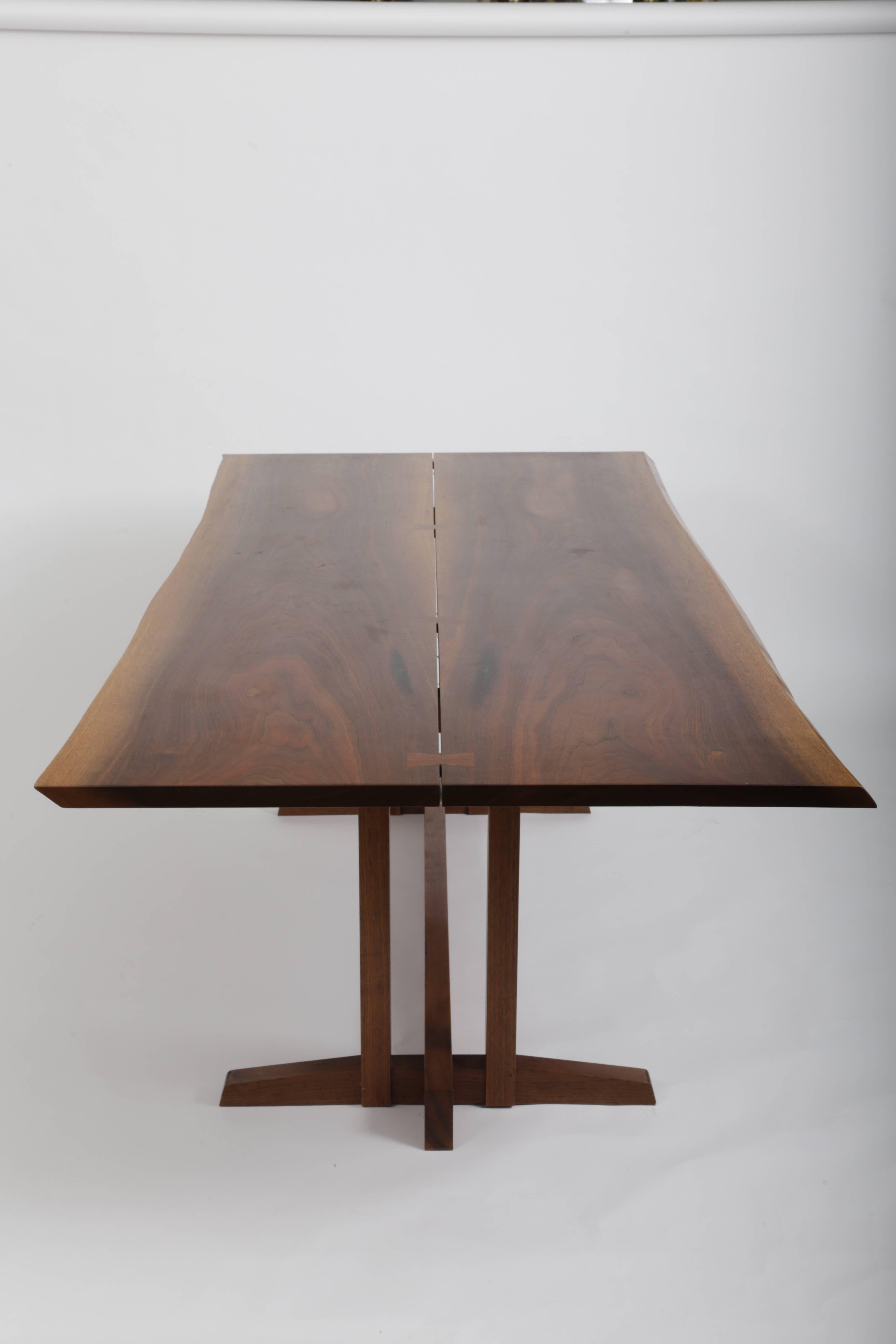 A wonderful bookmatched slabs of walnut joined by Walnut Butterflies,
Thick free edge top with great grain pattern,
Table is signed by Nakashima.