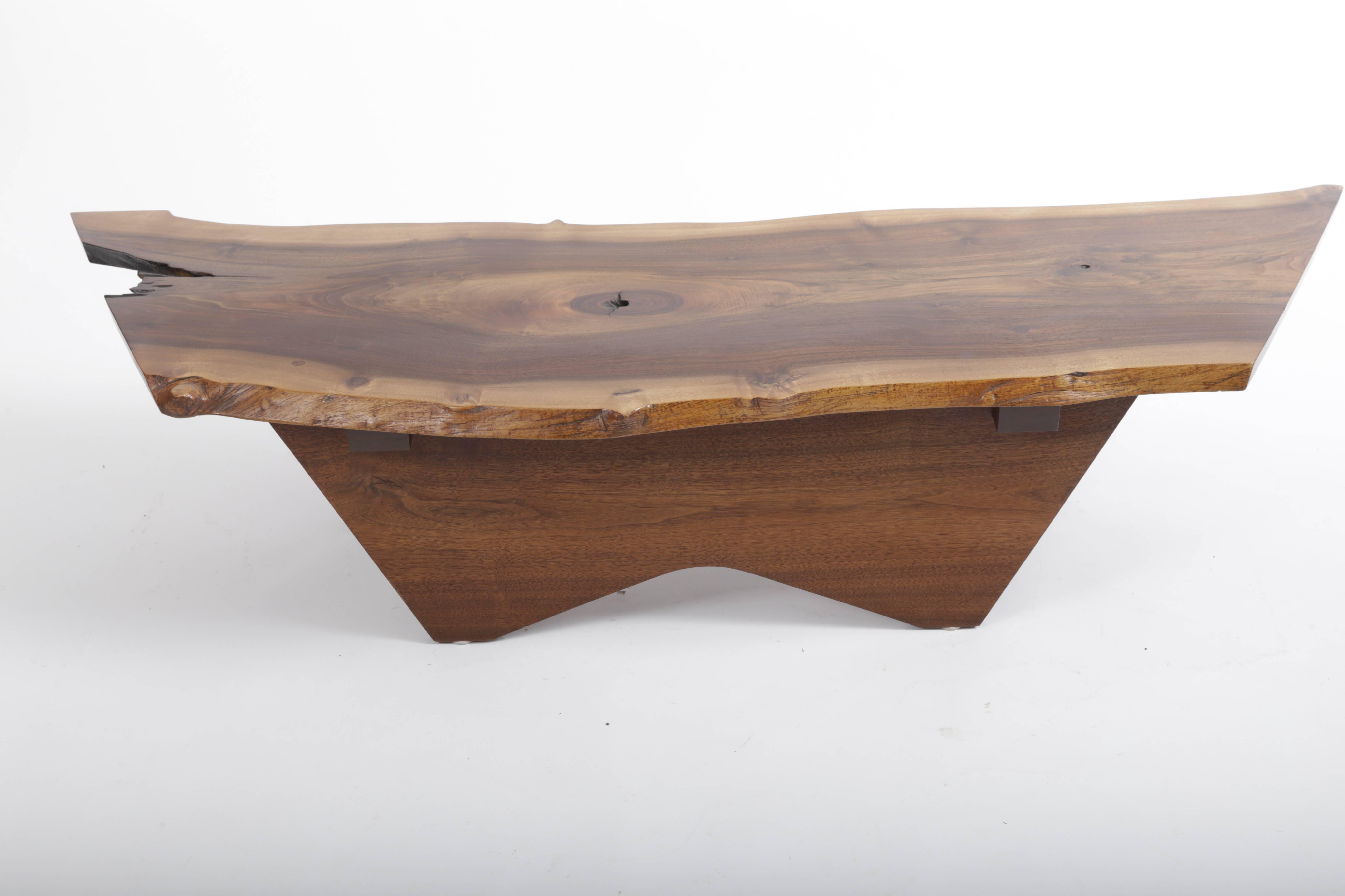 Free edge American black walnut top with very complex graining supported by canted walnut legs and butterfly base.
