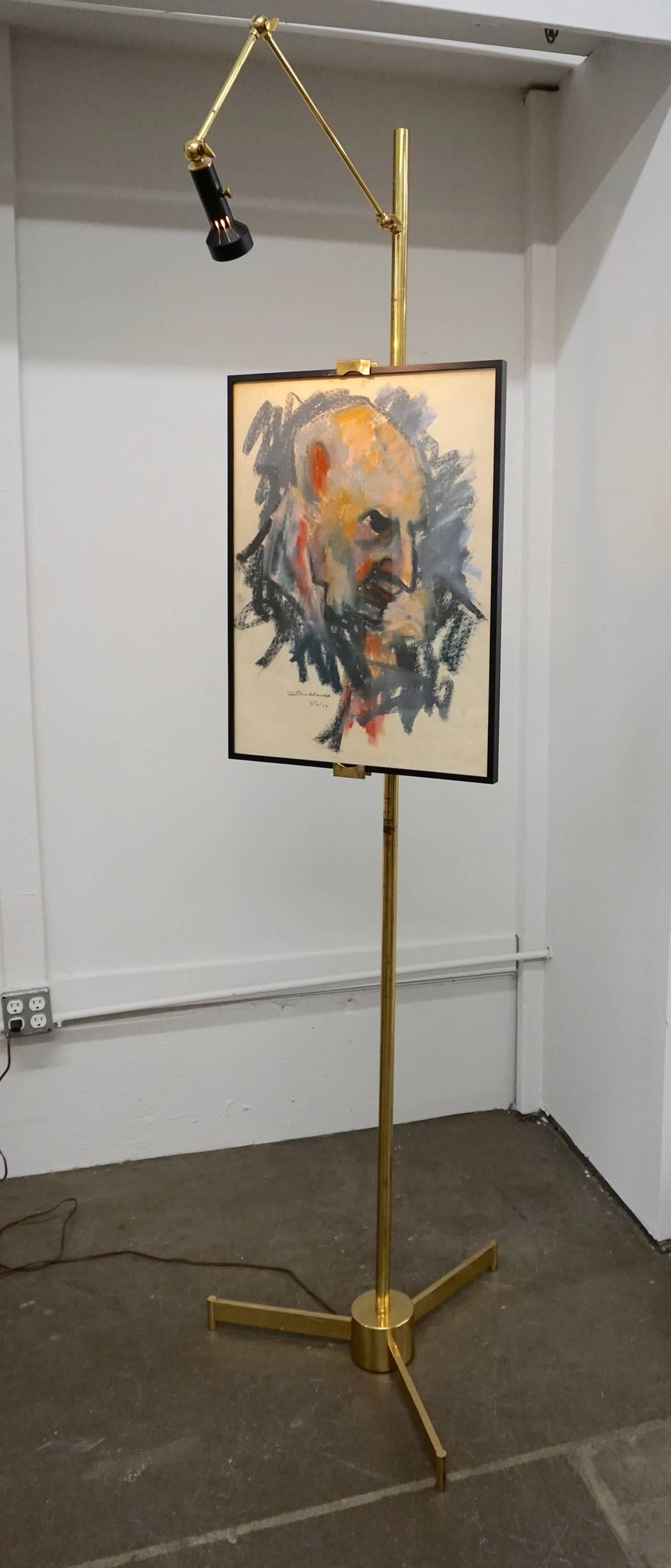 Adjustable clamps to secure artwork. The spotlight is fully adjustable to properly showcase your painting on this beautiful and unusual brass easel.