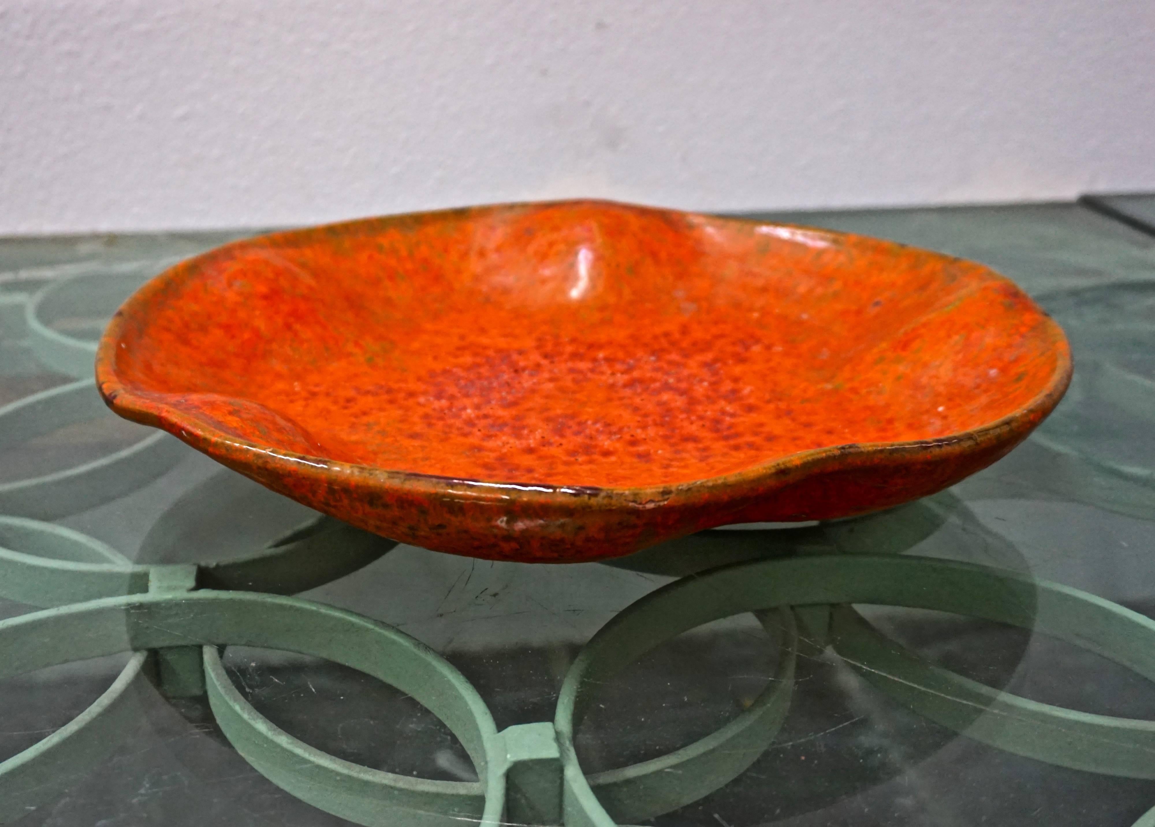 Burnt orange charger with a volcanic glaze, signed 