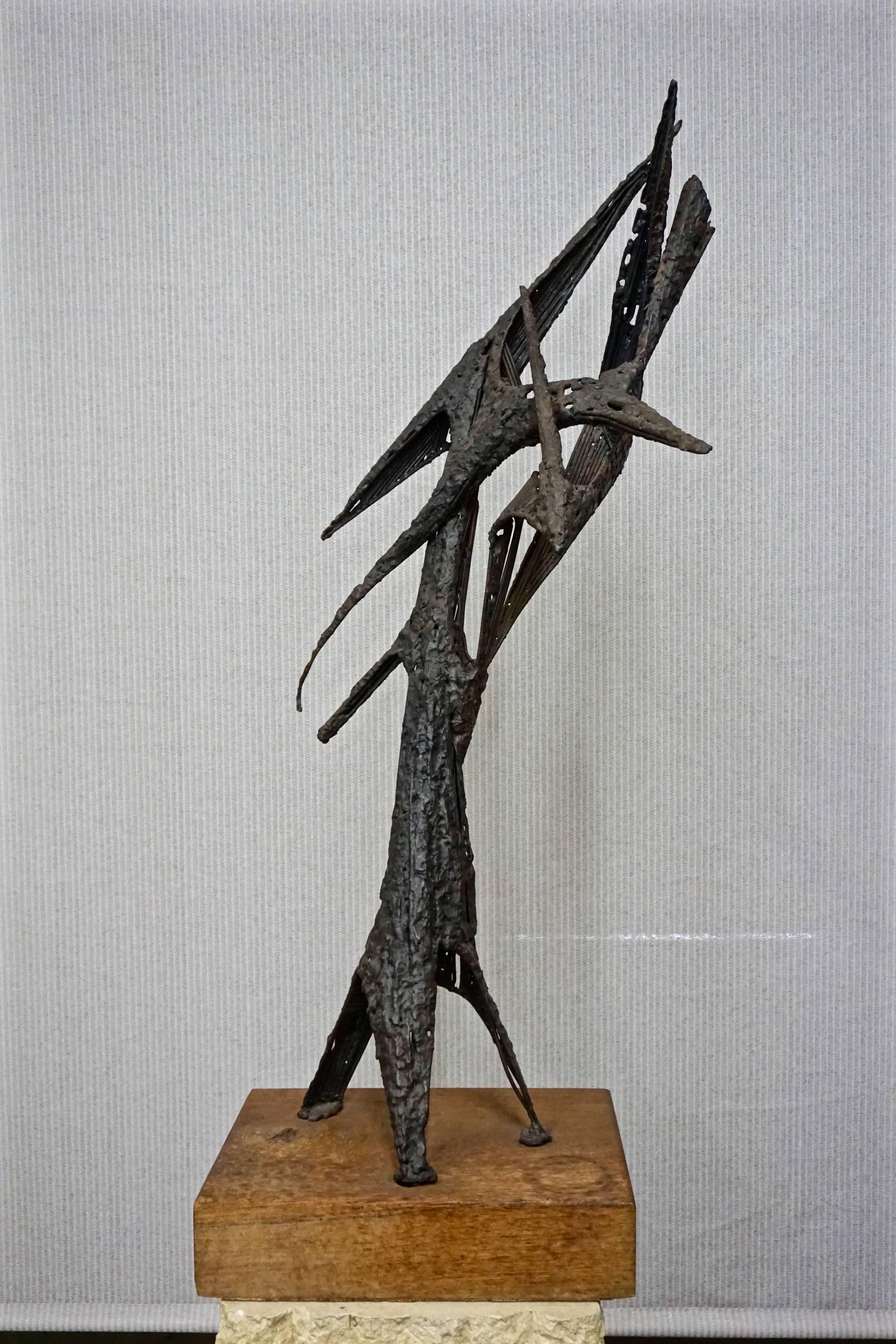 Torch cut and welded steel sculpture,unsigned.Mounted on wood stand.