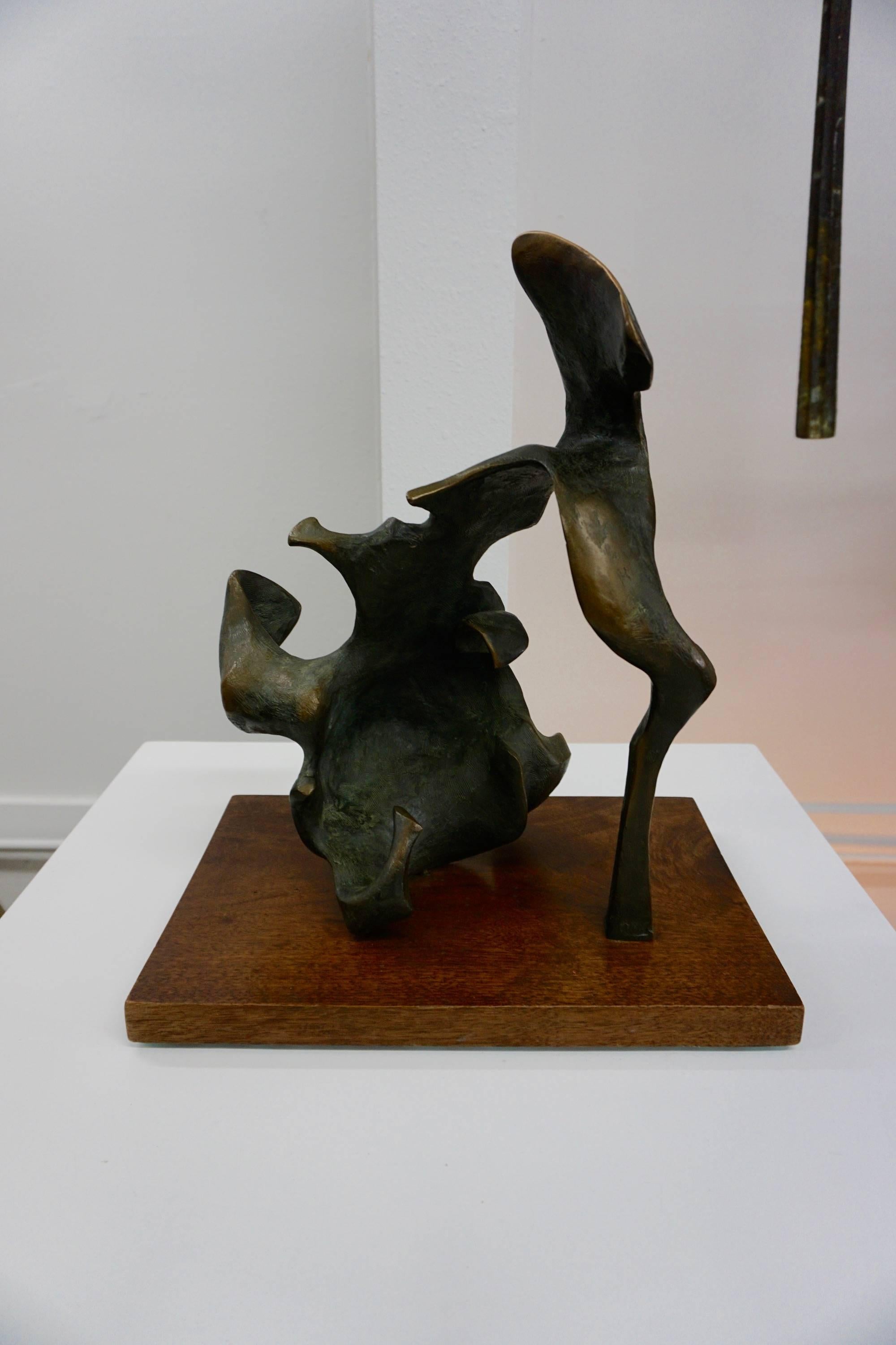 Nice example of a modernist abstract sculpture mounted on a walnut base.
Unsigned.