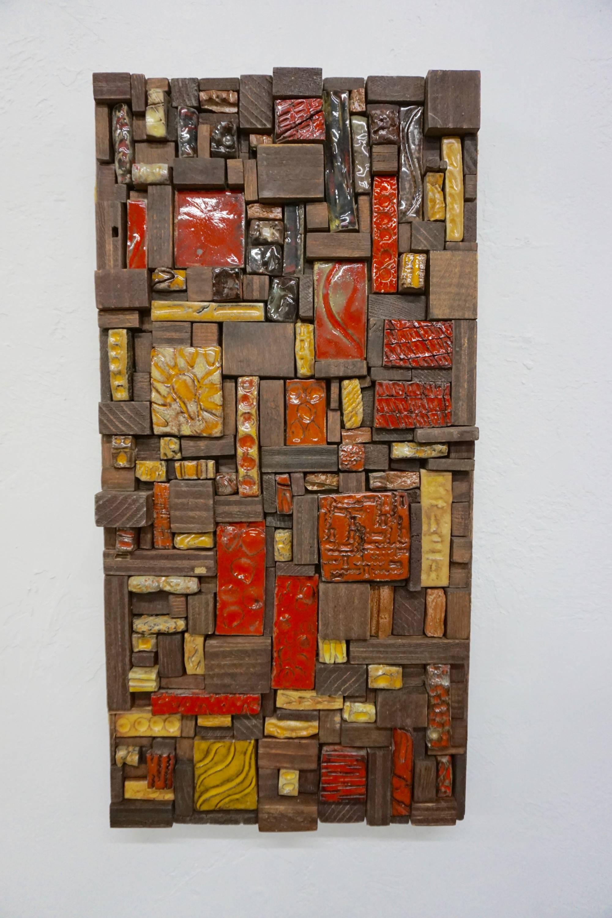 Glazed and etched tiles combined with wood blocks, mounted on a wood background.
Unsigned.