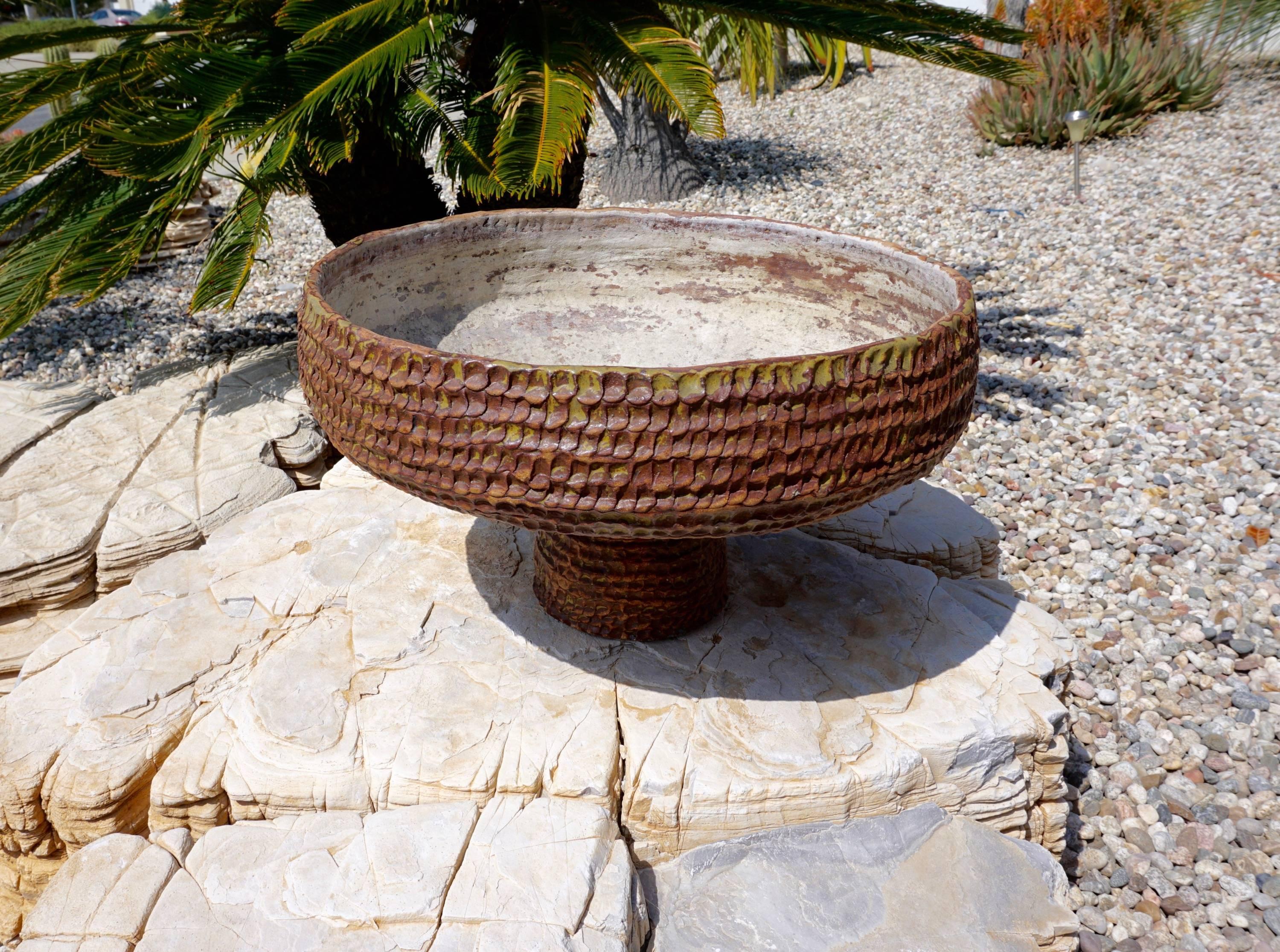 McFadden was based in Escondido Ca. This piece is reminiscent of Stan Bitters in that she used her thumbs to imprint the clay. This pot is signed both inside and on the base.
Excellent patina.