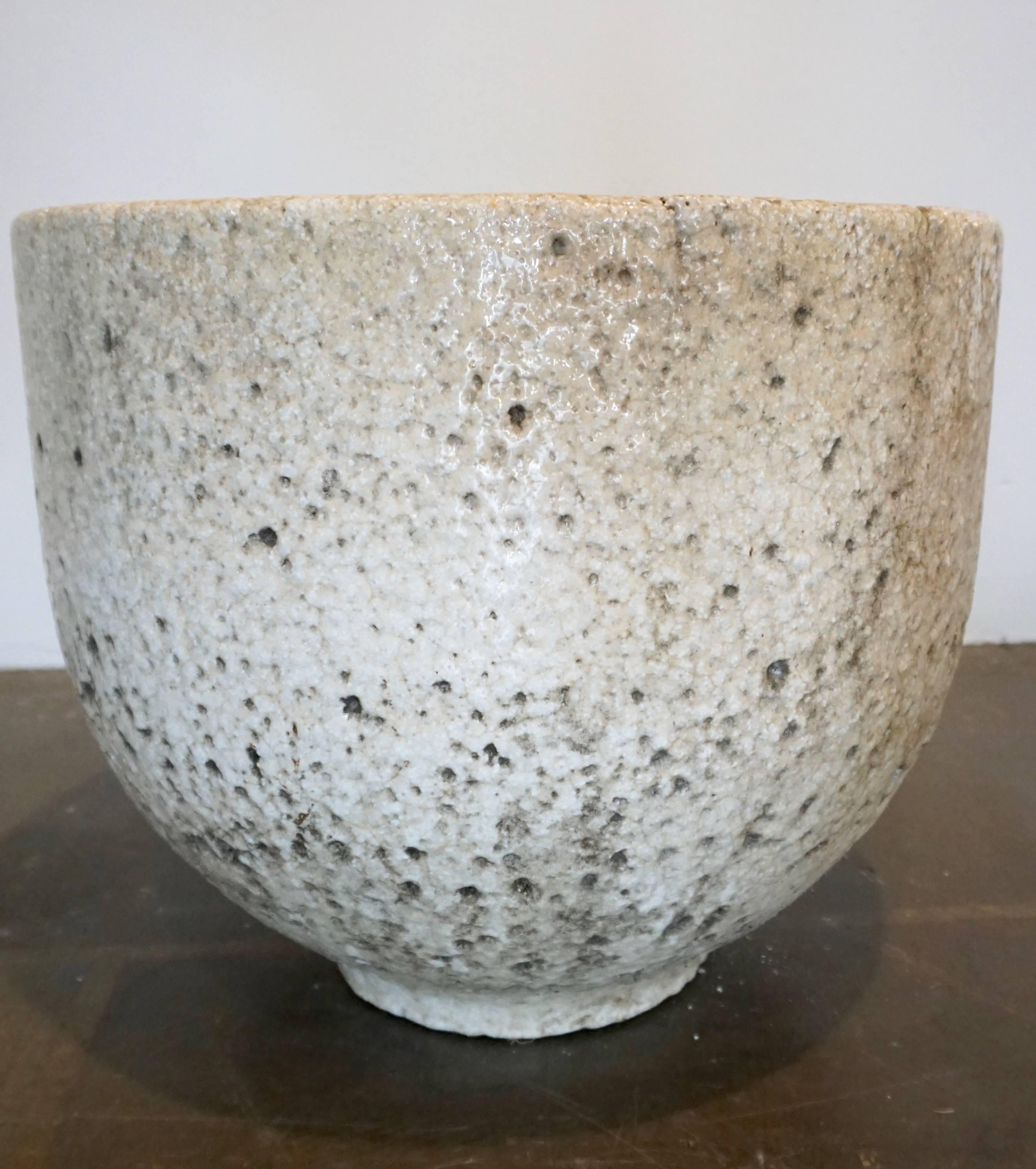 Ceramic vessel used to melt glass at very high temperatures. Remnants of melted green glass remain at the bottom of the vessel as well as staining of the vessel from the glass,enhancing its beauty. Can be used as a planter or a decorative object,