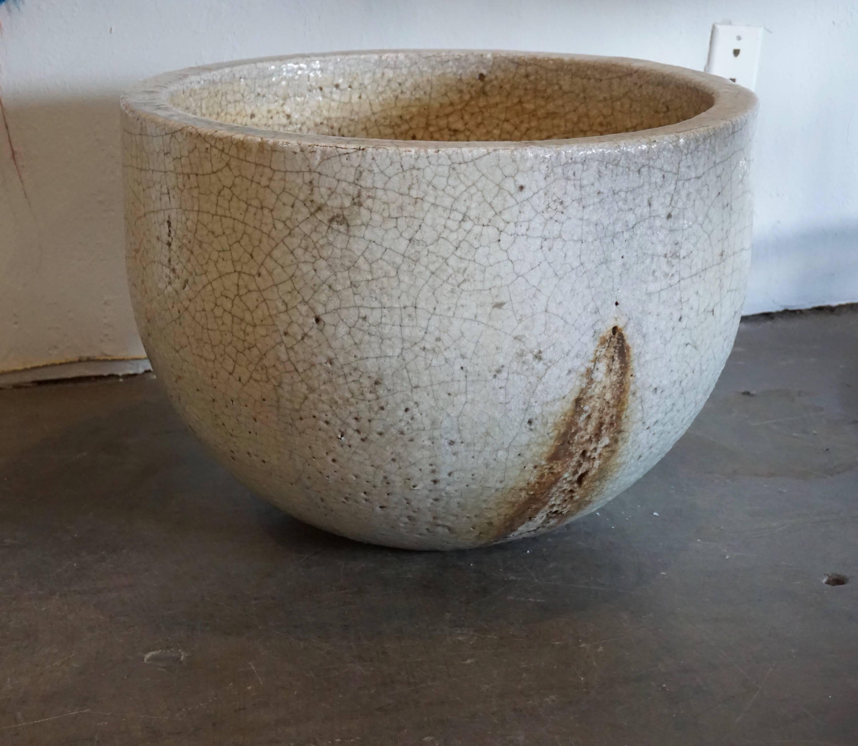 Ceramic vessel used to melt glass at very high temperatures. Enhanced by the crackling and the glass remnants and drippings. Can be used as a planter or decorative object, indoors or outdoors.