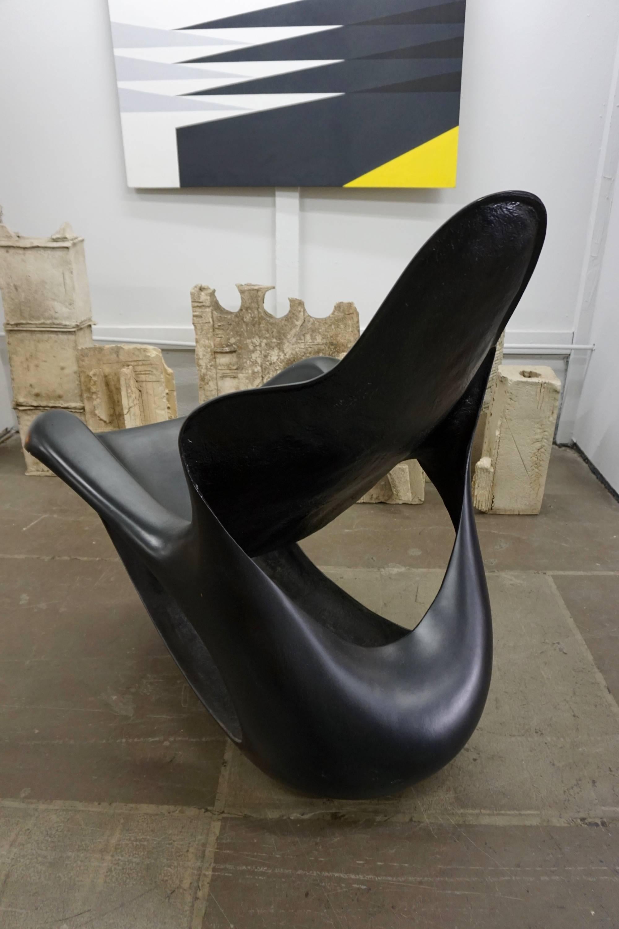Moulded black, stylish rocker, sculptural, comfortable and conducive to any indoor or outdoor setting.