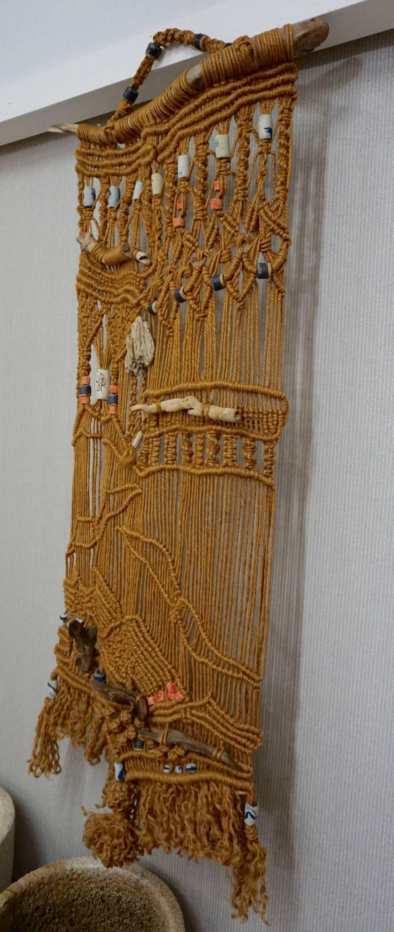 Excellent example of jute macrame imbedded with ceramic beads, stones and driftwood.