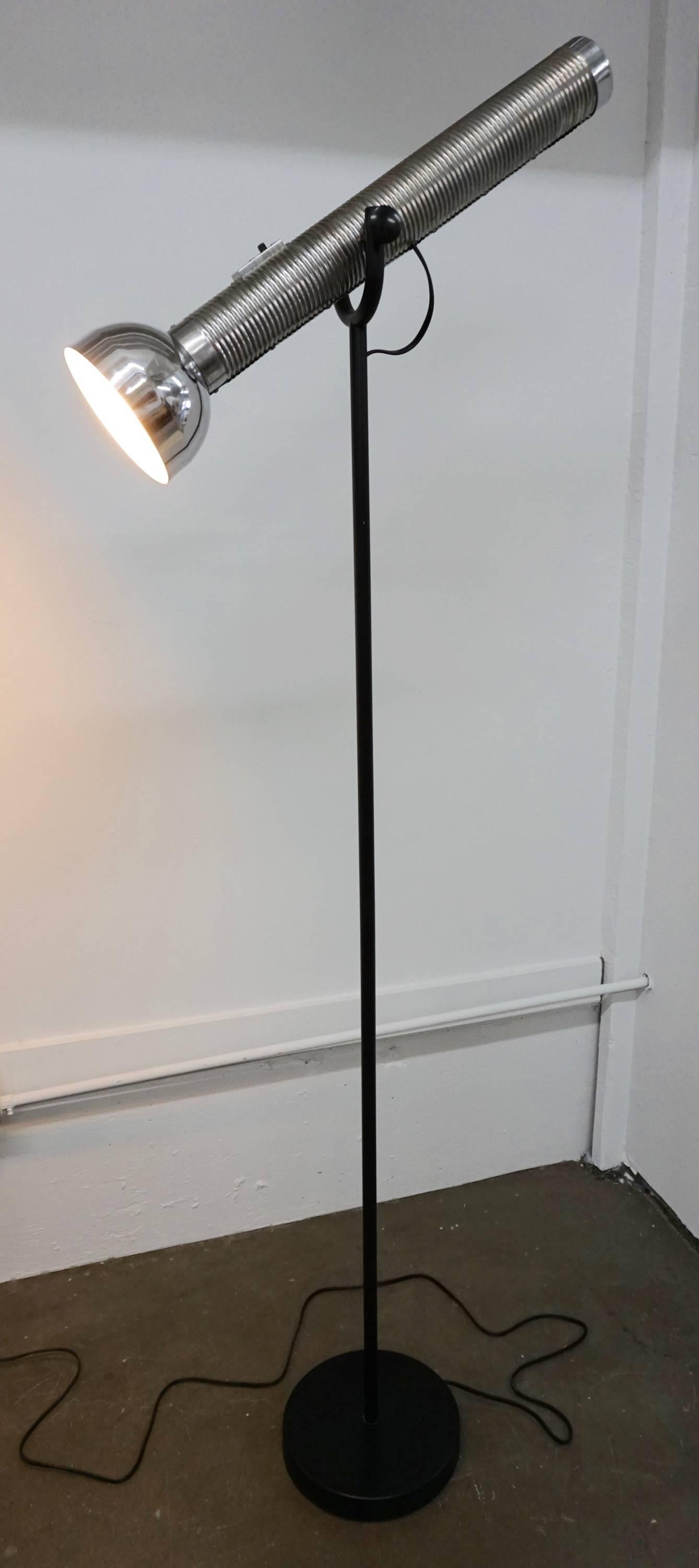 Designed by Curtis Jere and made to resemble an oversized 1950s flashlight.
Adjustable lamp mounted on a black steel base. 10" diameter at base.