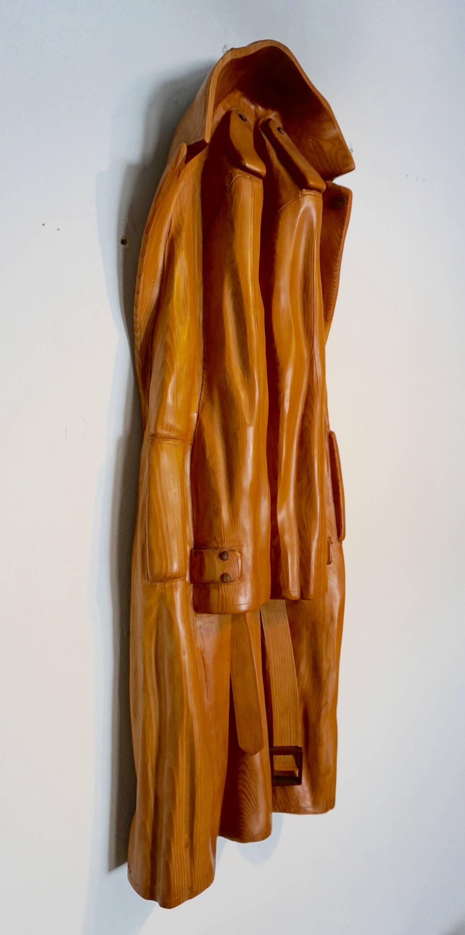 Hand-carved and sculpted out of sugar pine by Laguna Beach artist, Rene Megroz in 2002, signed and dated.
One of these trenchcoats by Megroz is part of the Smithsonian collection.