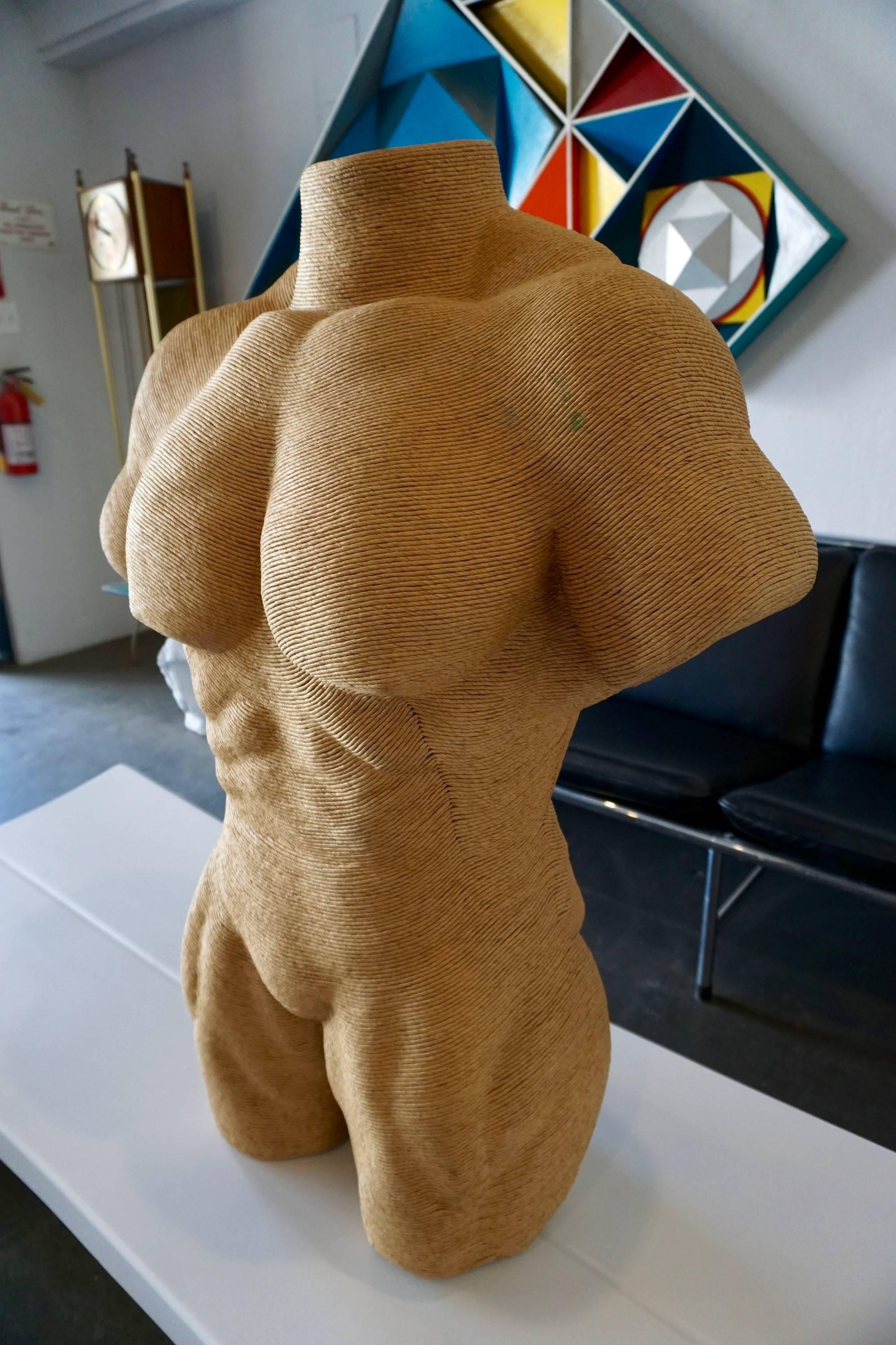 Molded torso wrapped in jute twine. Muscular body builder showing extreme physique.