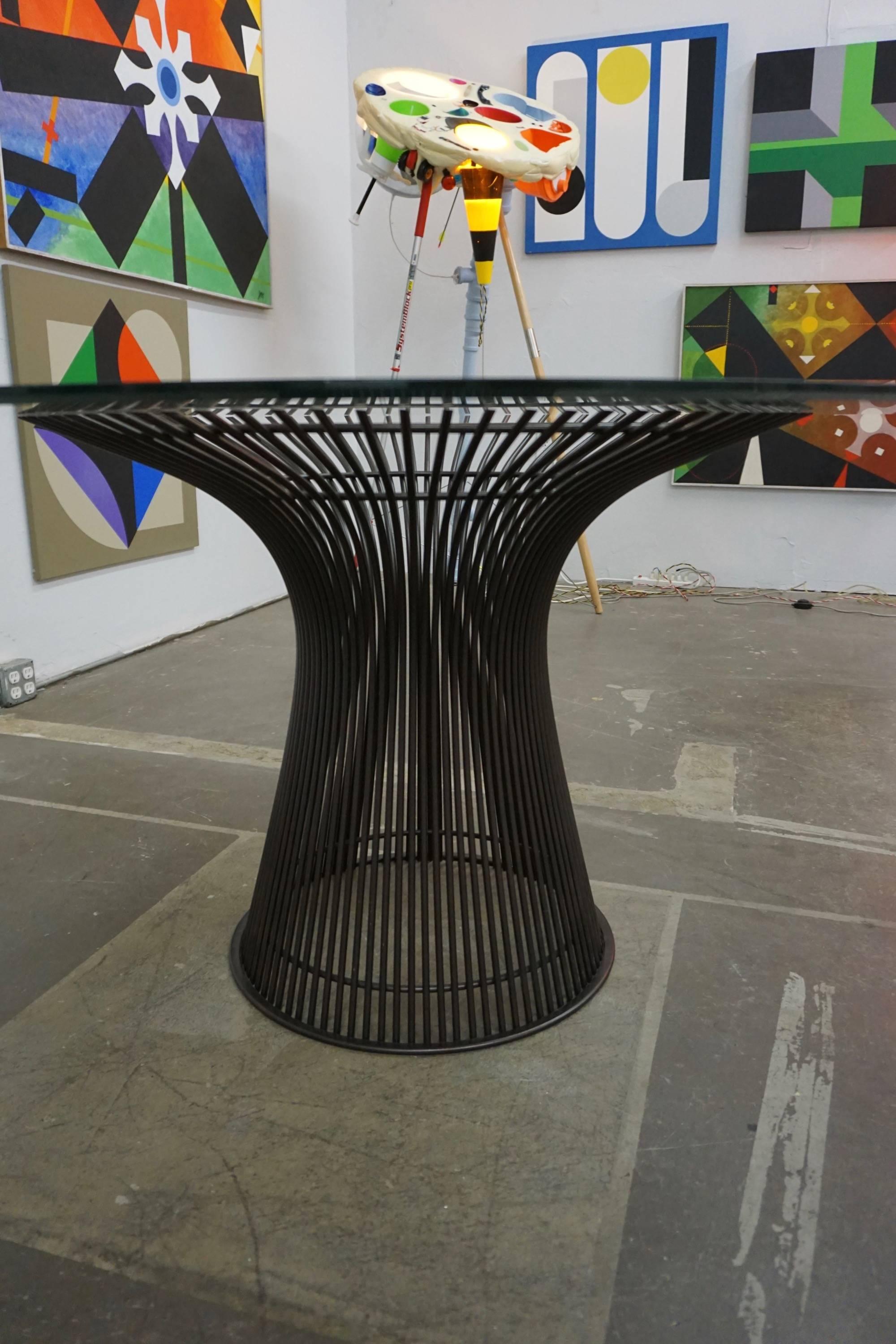 Designed by Platner in 1966 and manufacture by Knoll. The base has a bronze finish and the glass top measures 54