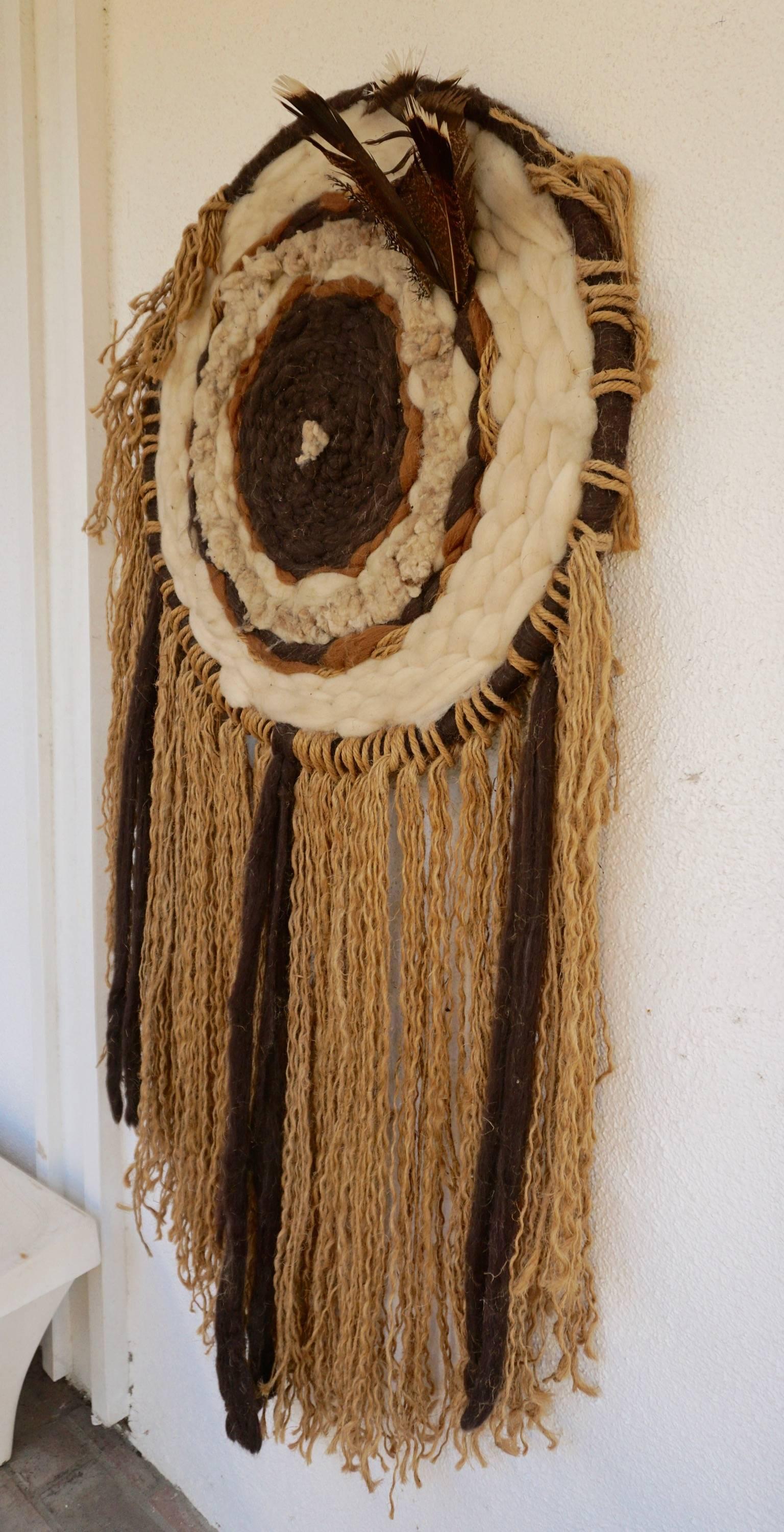 Made up of tufted wool, feathers and strands of jute.