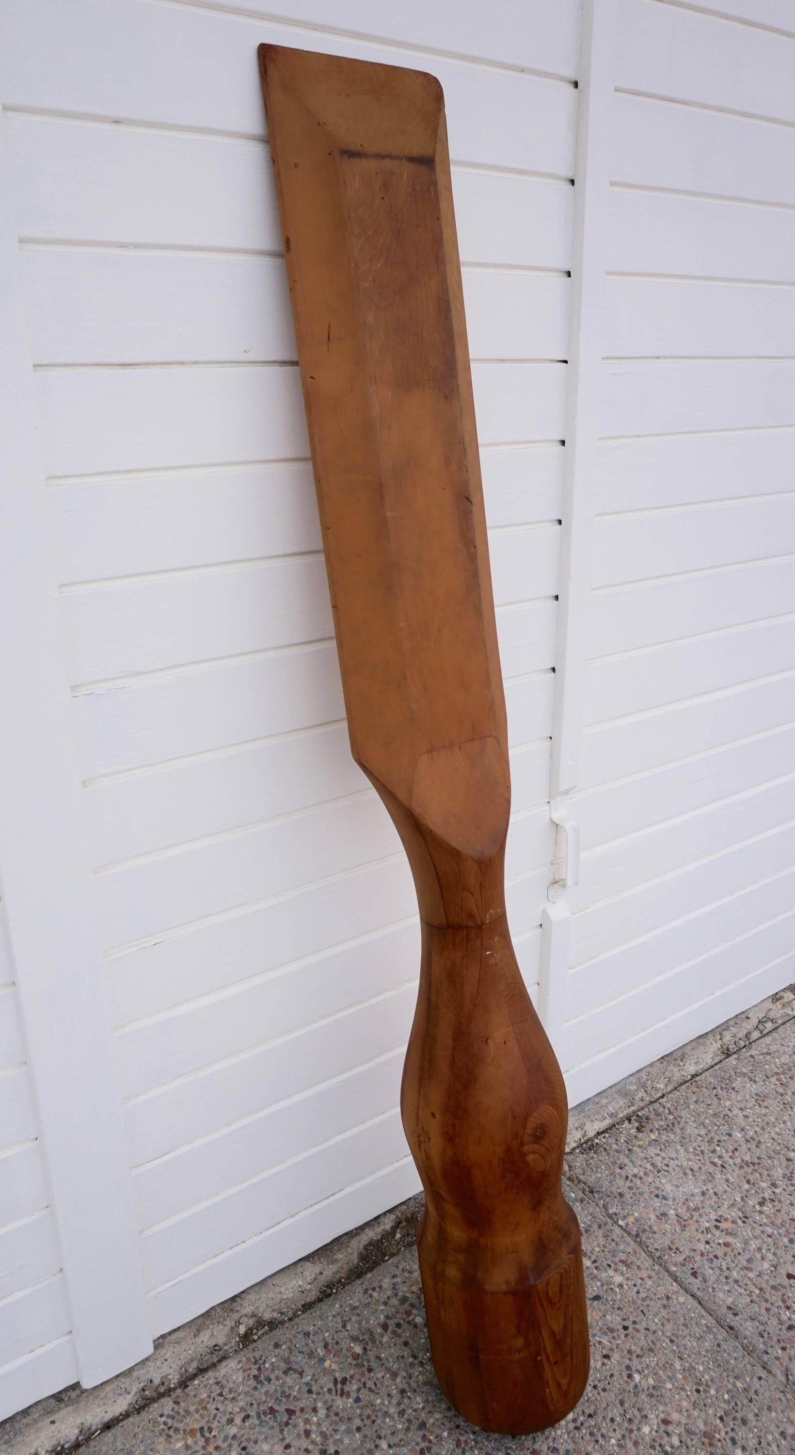 Sculpted from solid laminated redwood. Can be mounted to or leaned against a wall.