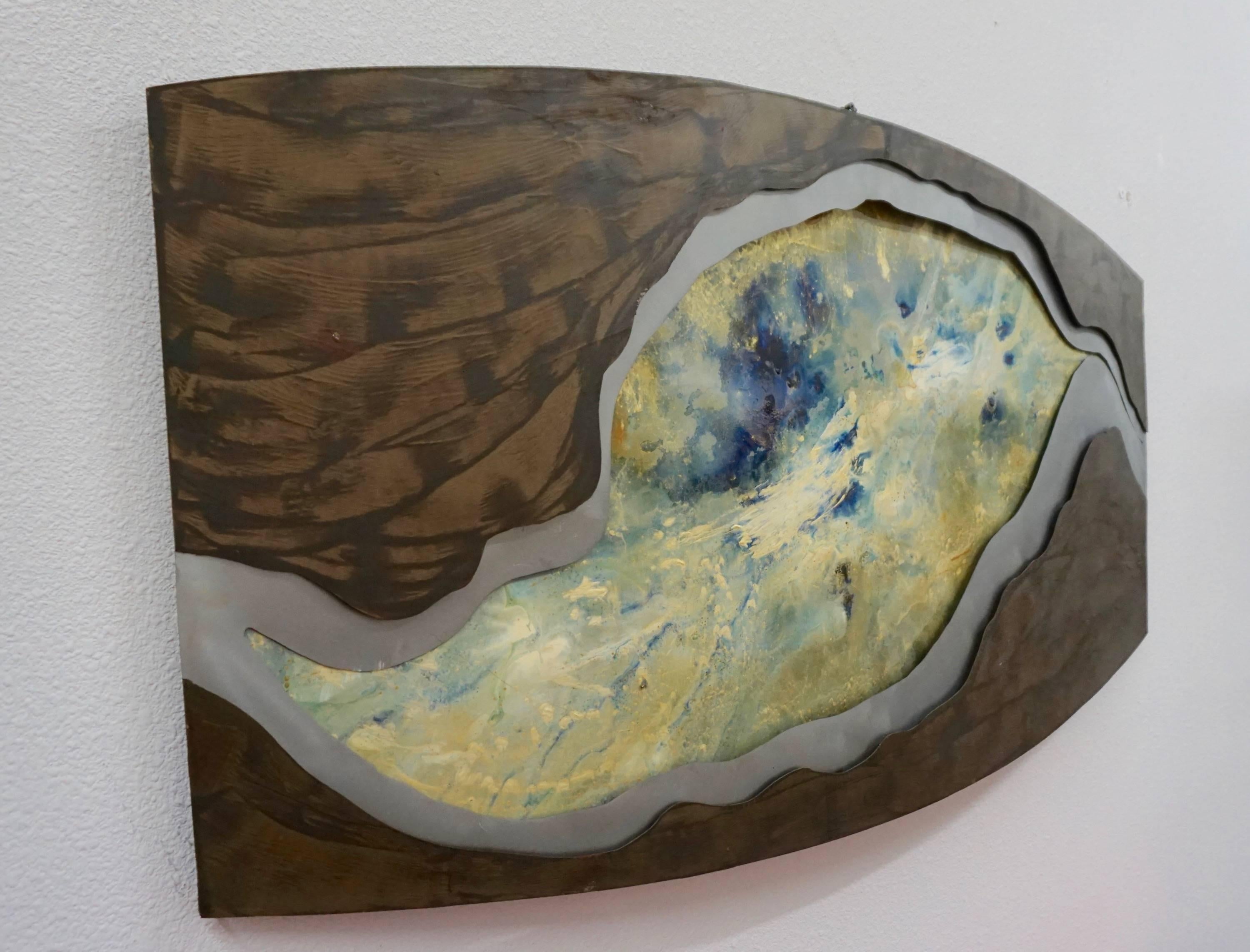 Three layers of sheet metal mounted together and painted to create this surreal work of art.