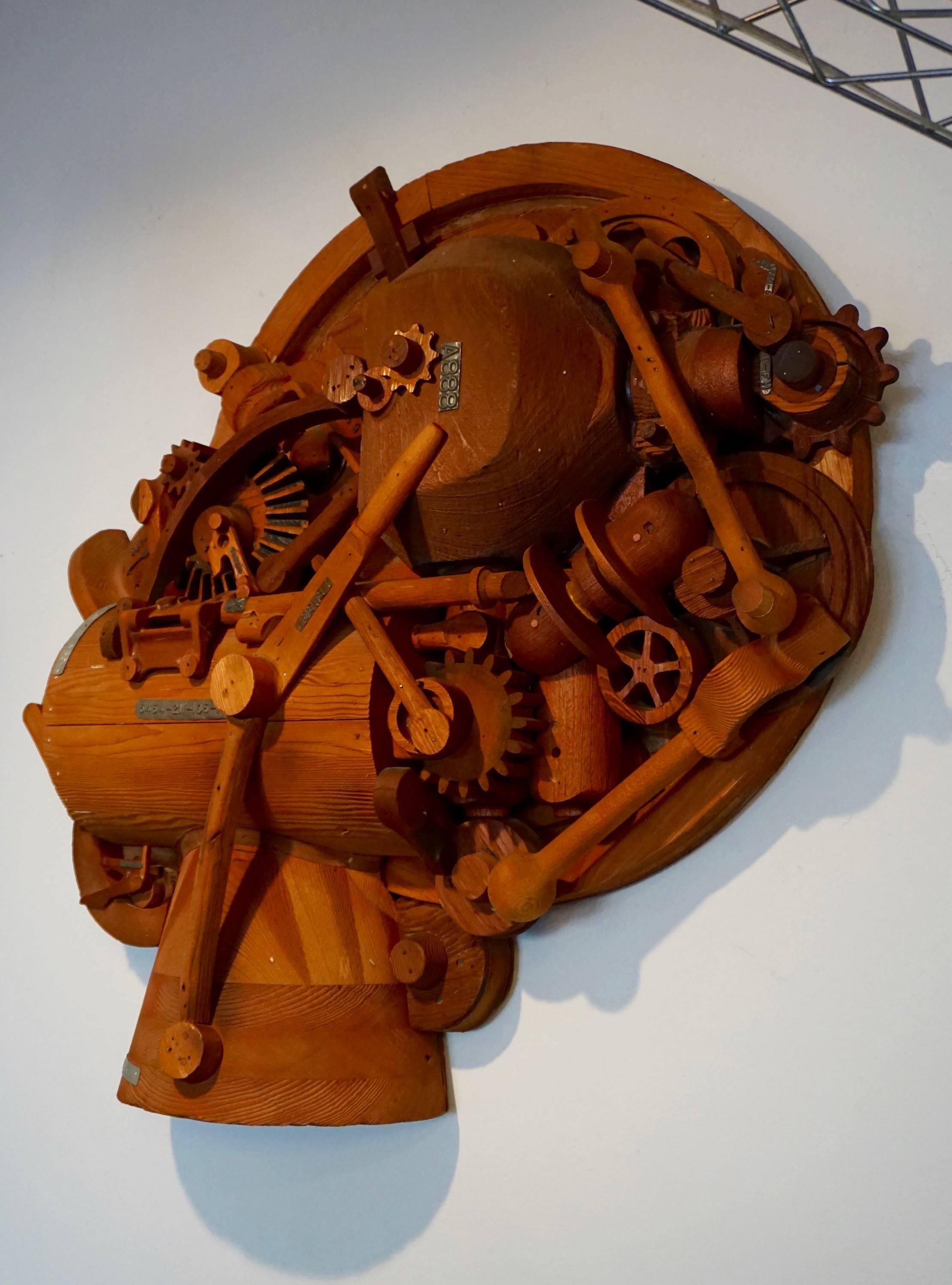 Assemblage of hand-carved redwood tools, gears and pulleys with metal serial numbers. This piece was part of the Bullocks, Los Angeles store display.