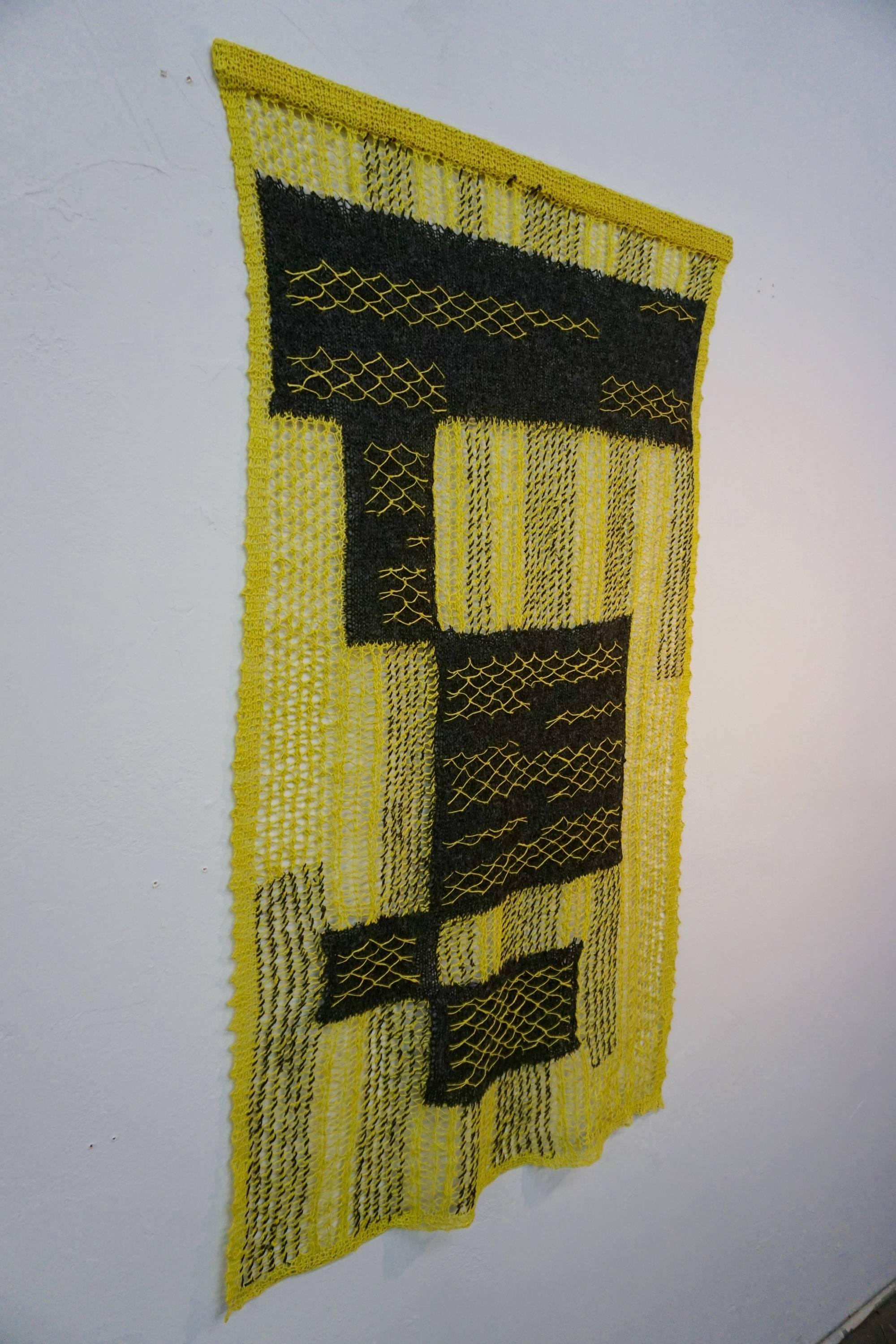 Fine wool threads, dyed and woven into an airy abstract wall hanging. Measures 52