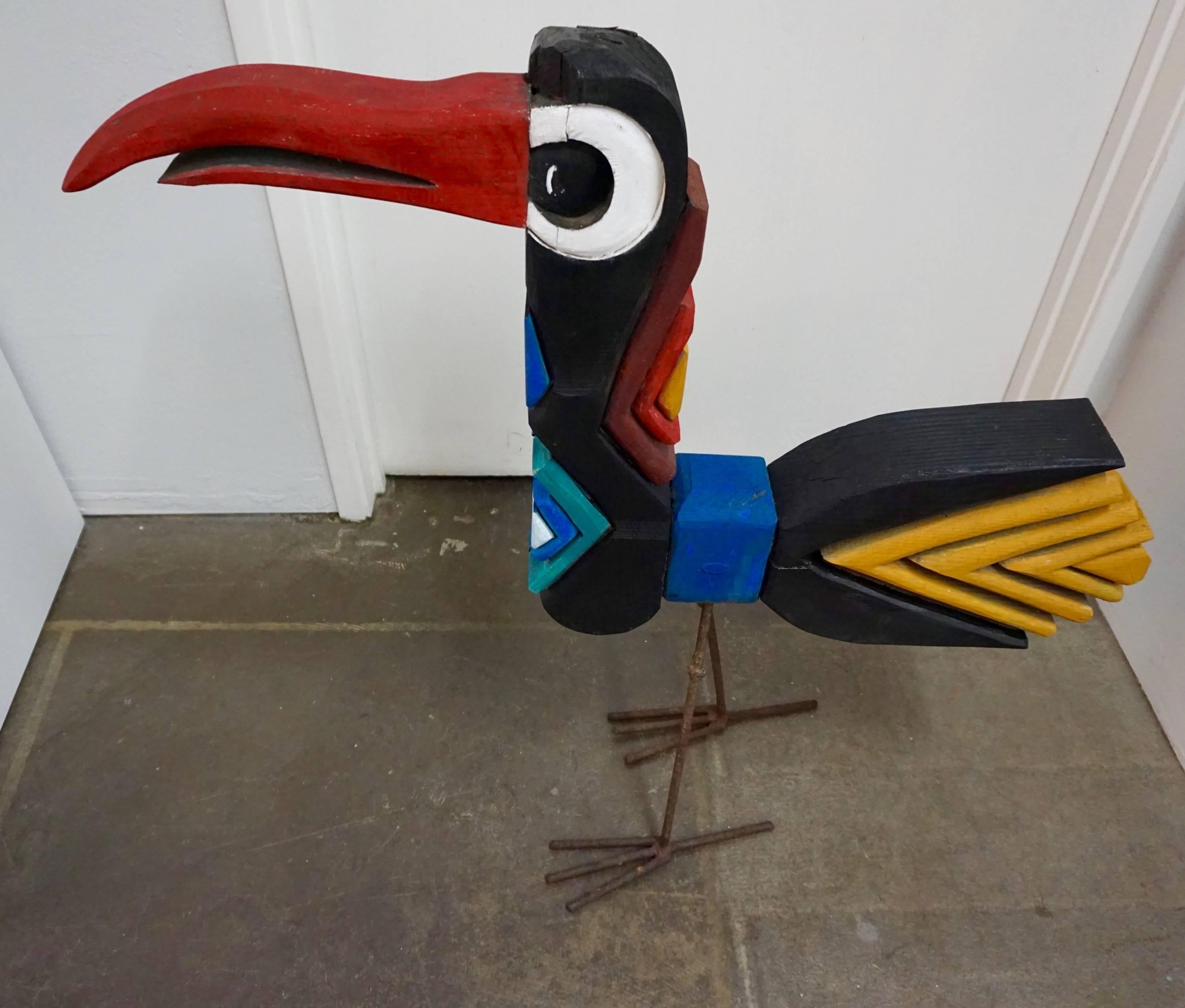 Sculpted from recycled wood, brightly painted, with welded rebar legs.