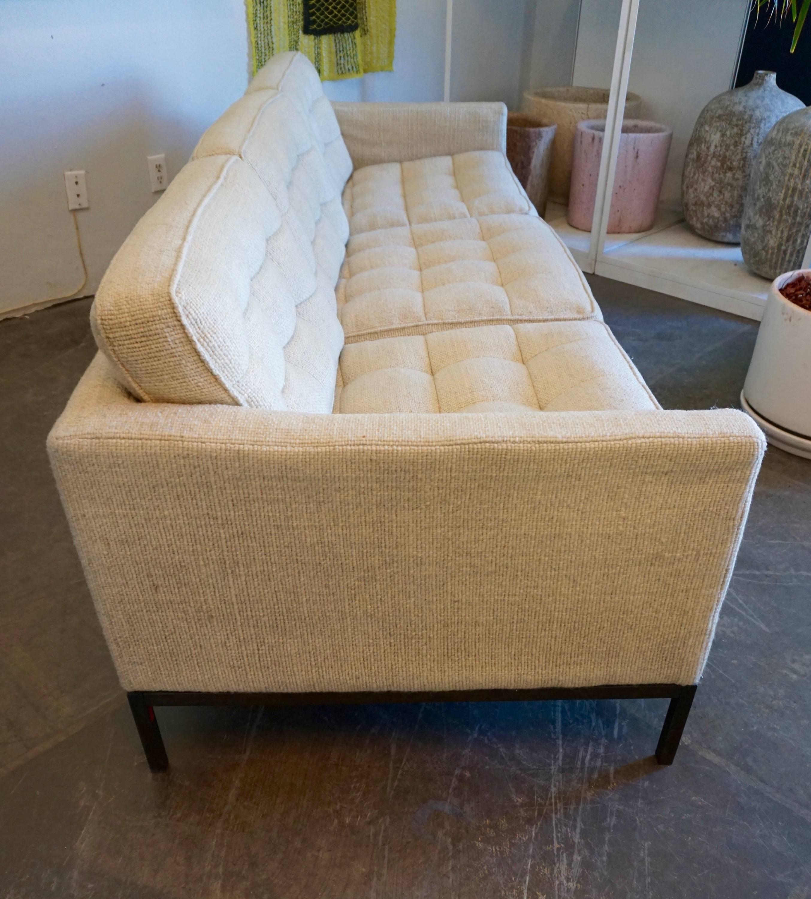 Timeless design, Knoll wool fabric, tufted and box stitched on a bronzed steel base.