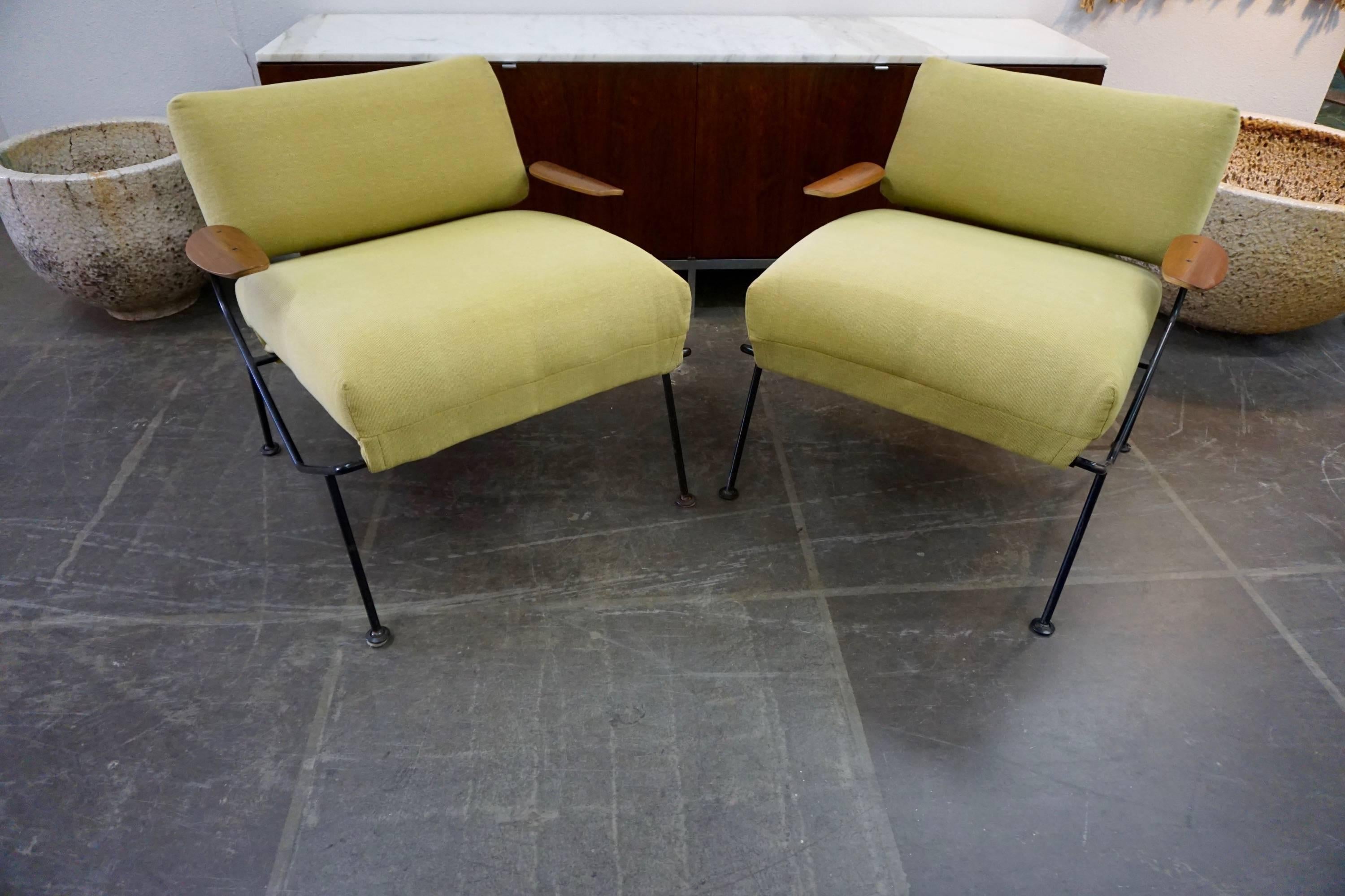 Designed by Dan Johnson in the 1950s for the Selig Furniture Co. Wrought iron frames, pea green cotton fabric, walnut bent plywood armrests.