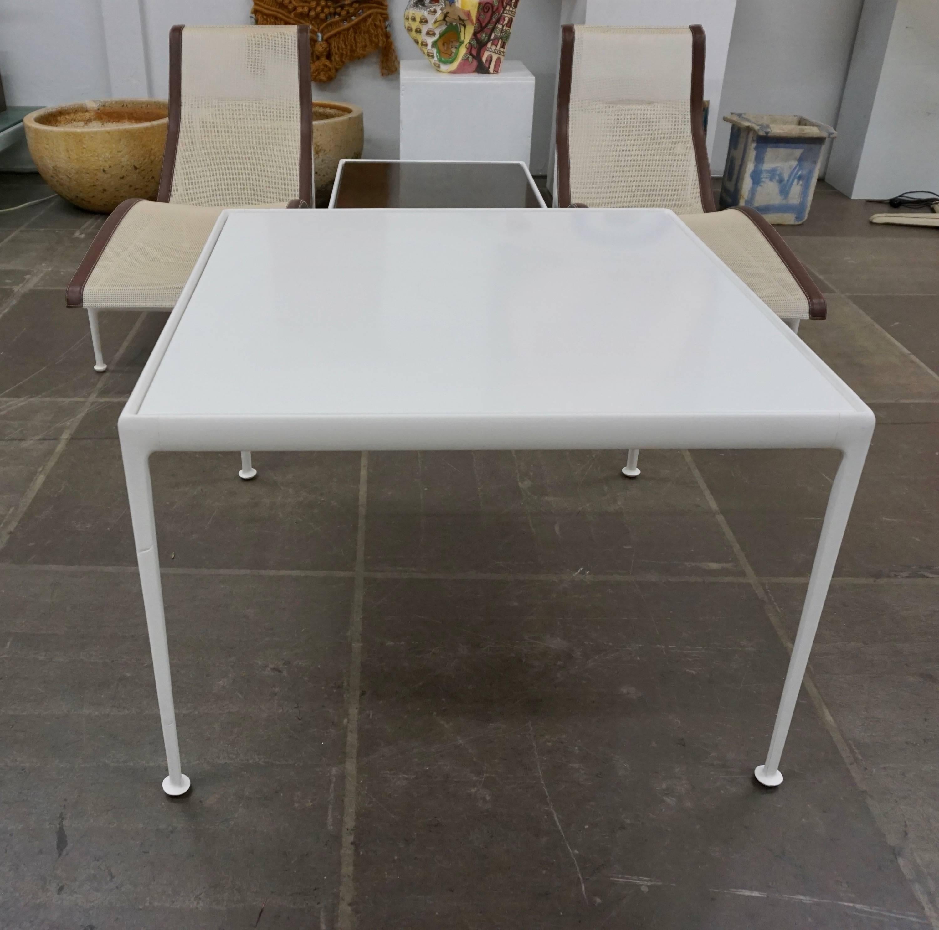 Richard Schultz outdoor dining table for Knoll. This table has a white powder-coated cast and extruded aluminum frame with white enameled porcelain on steel tabletop. The table has a weather resistant finish and a slight gap between the top and