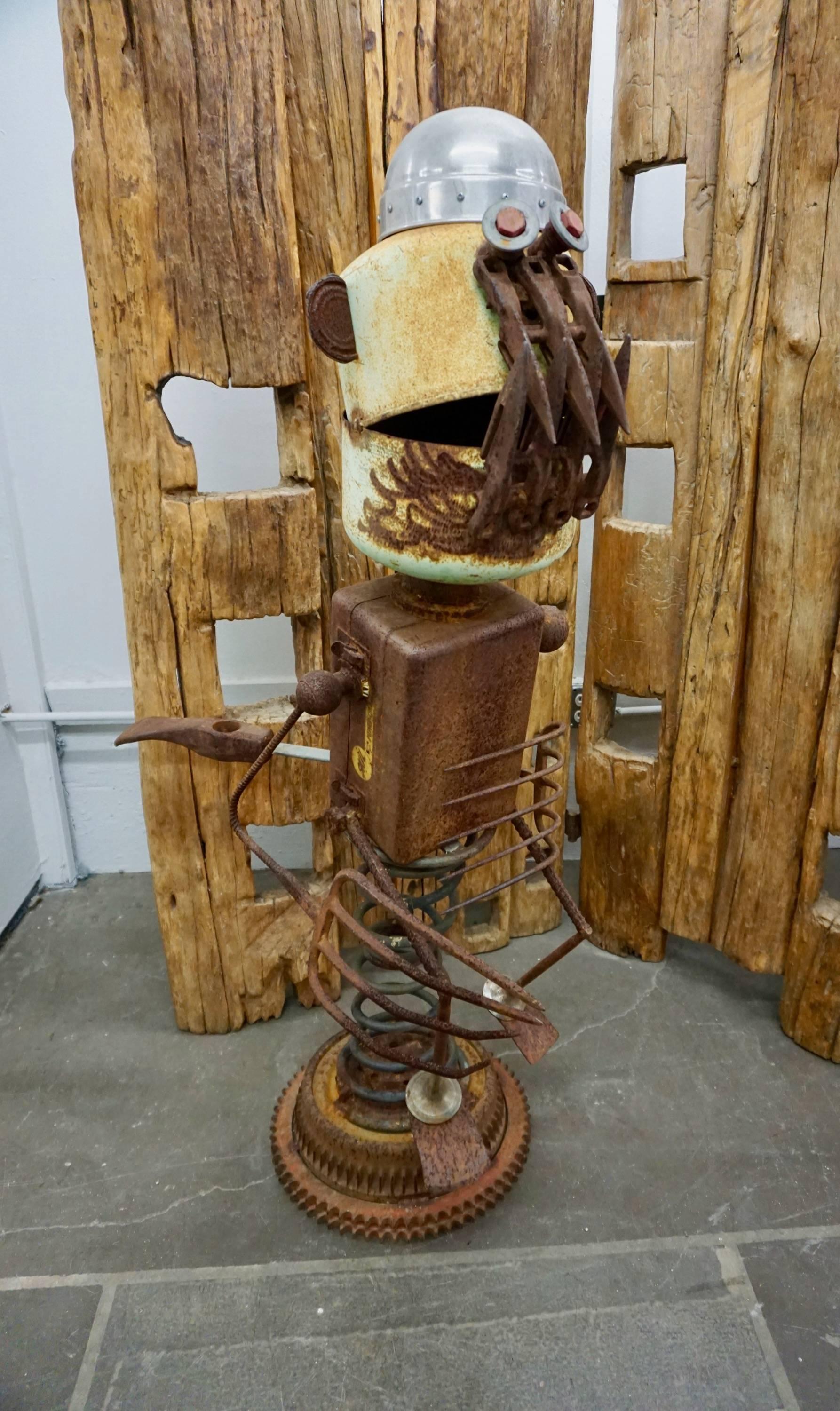This ferocious looking creature was assembled by Mr. Bauer from rusty farm implements and car parts. The base of the sculpture is mounted on a coiled spring which allows it to sway in the breeze.