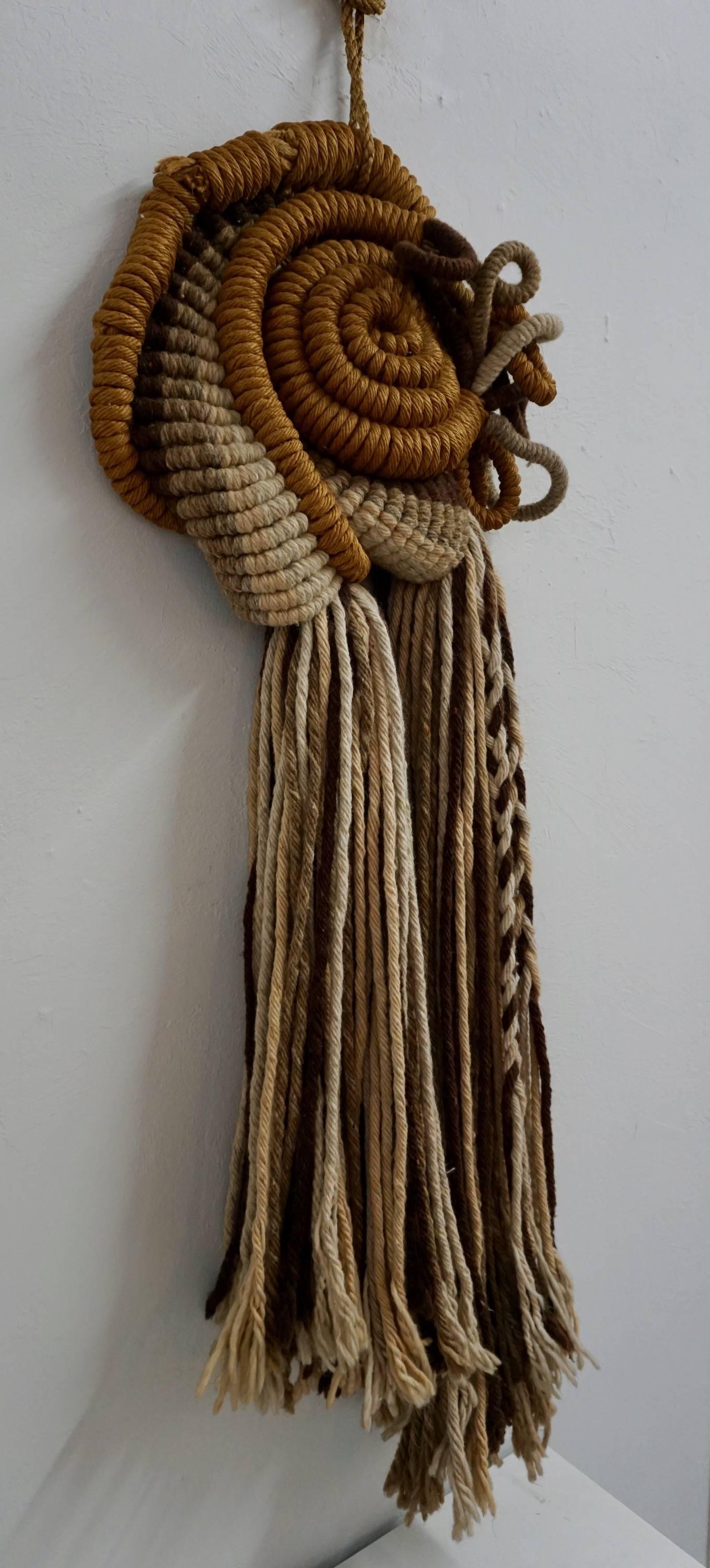 Unusual combination of rope, yarn and twine creating a very interesting wall hanging.