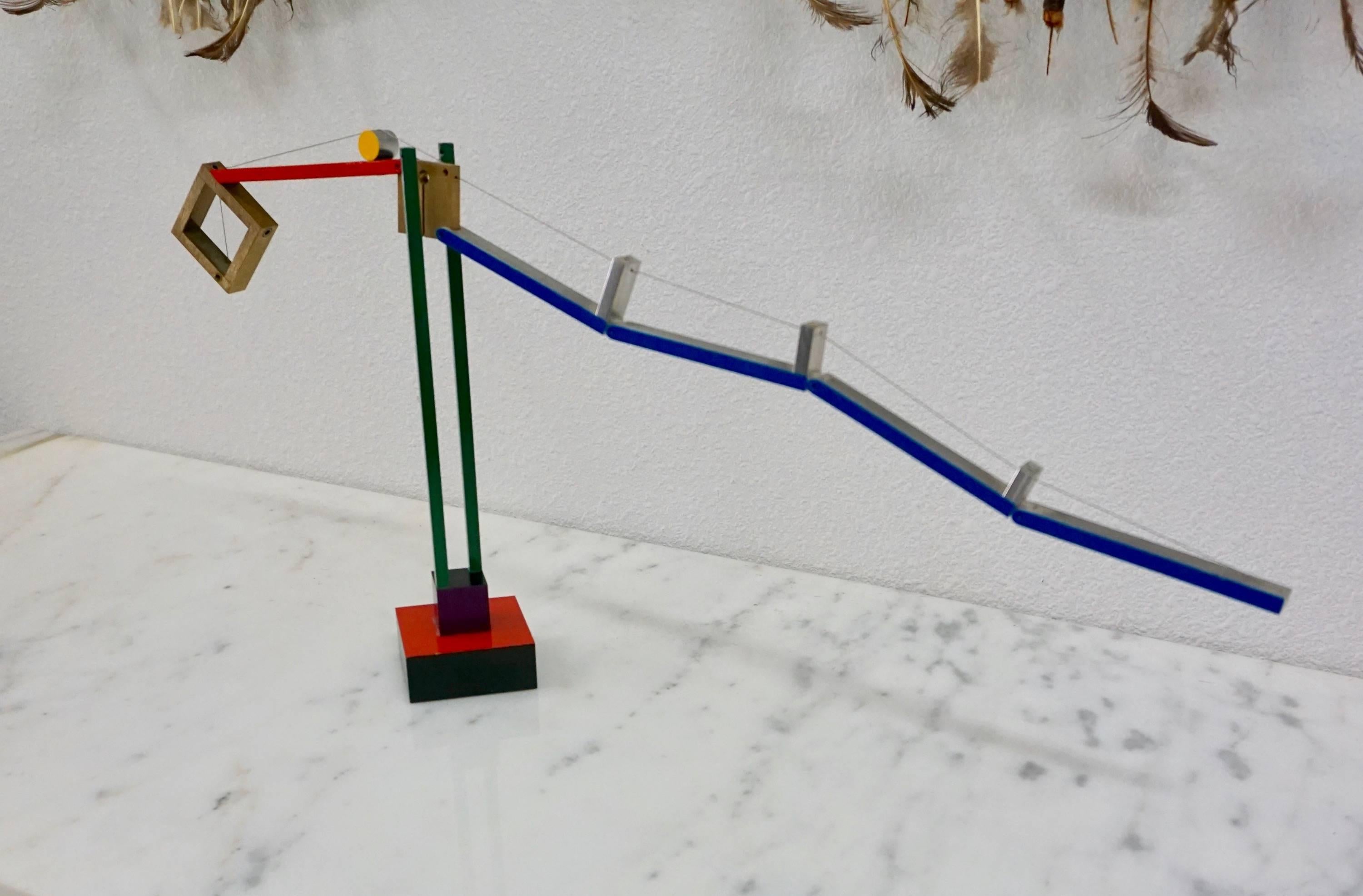 A painted aluminum and steel cable sculpture.
The sculpture has a counterweight and is
balanced on an I beam base.
Signed 