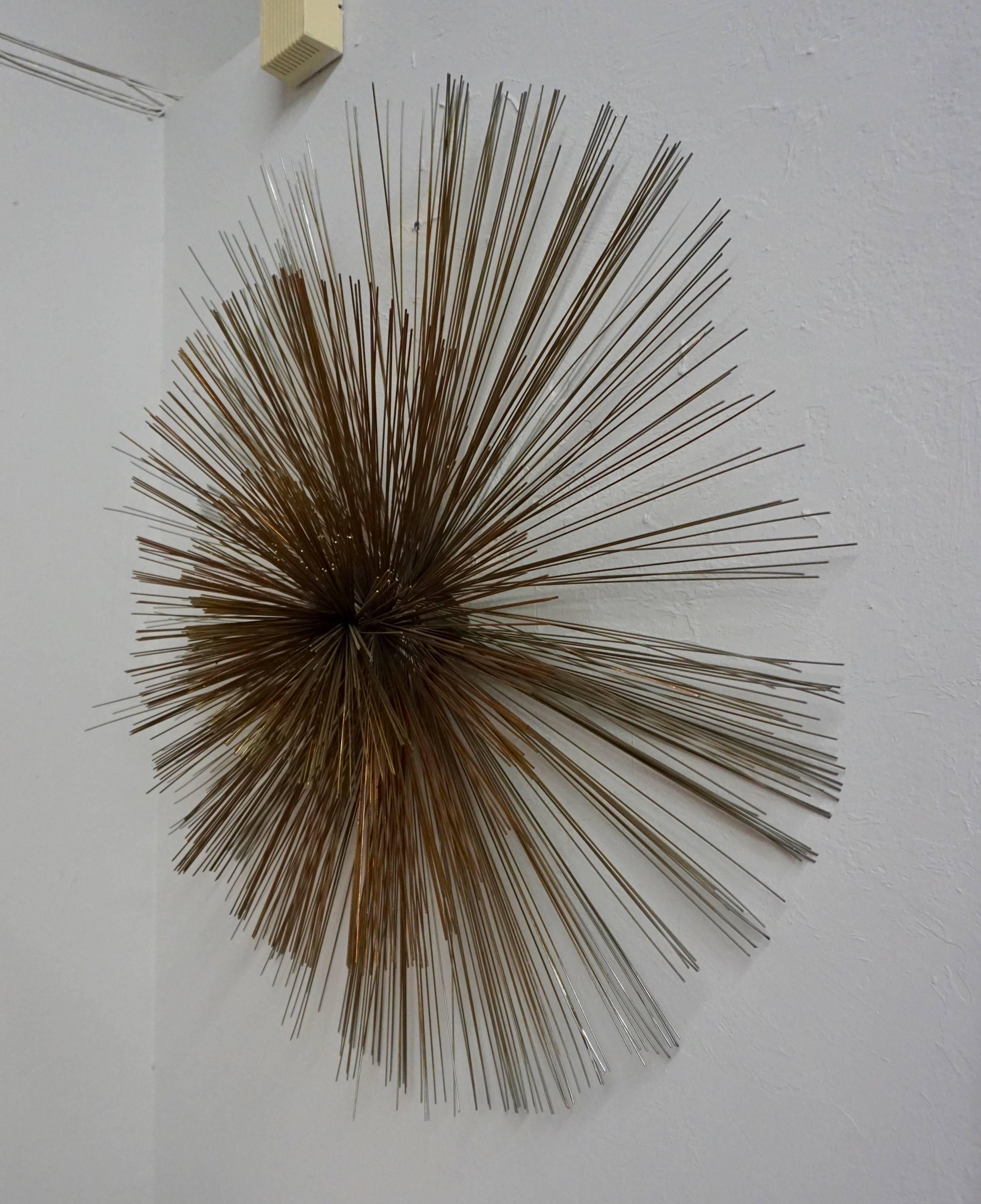 Radiating metal rods welded together to create a sunburst effect.