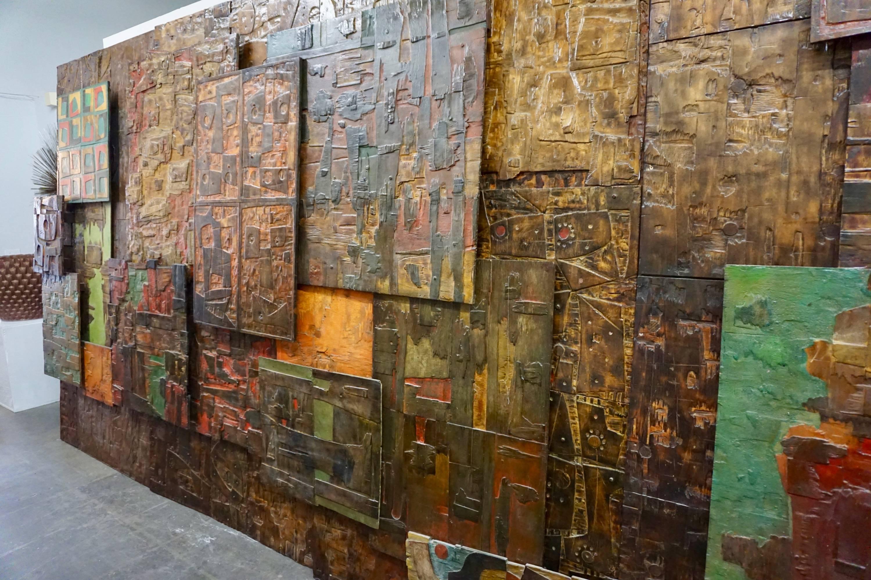Multiple panels of abstract paintings on board attached together in relief creating a huge assemblage measuring 193