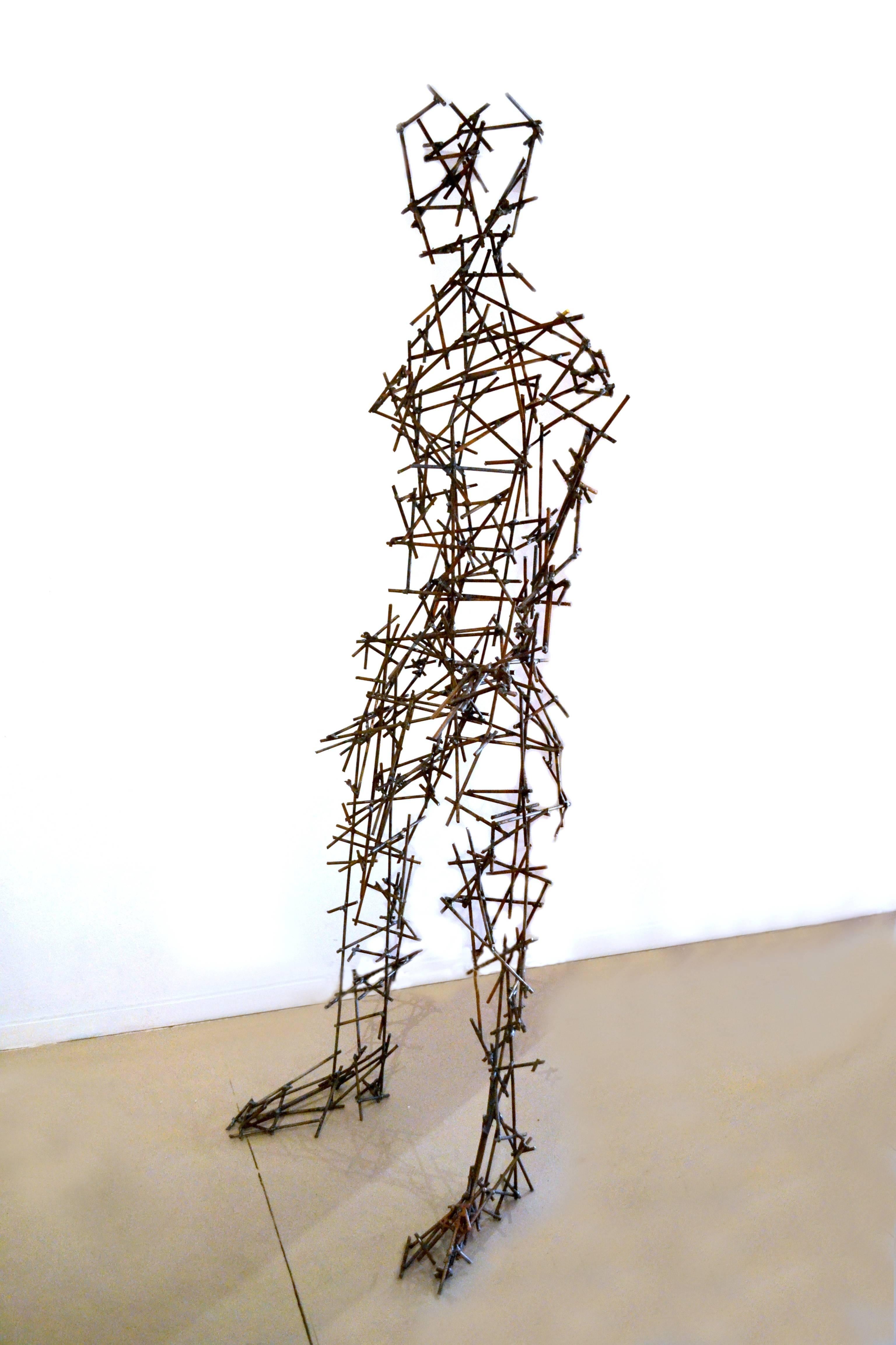 Stunning, whimsical and extraordinary in design and execution are but a few adjectives that describes this lifesize male figure. 

This abstract figure is fabricated out of steel posts that have been meticulously welded in place. The extended