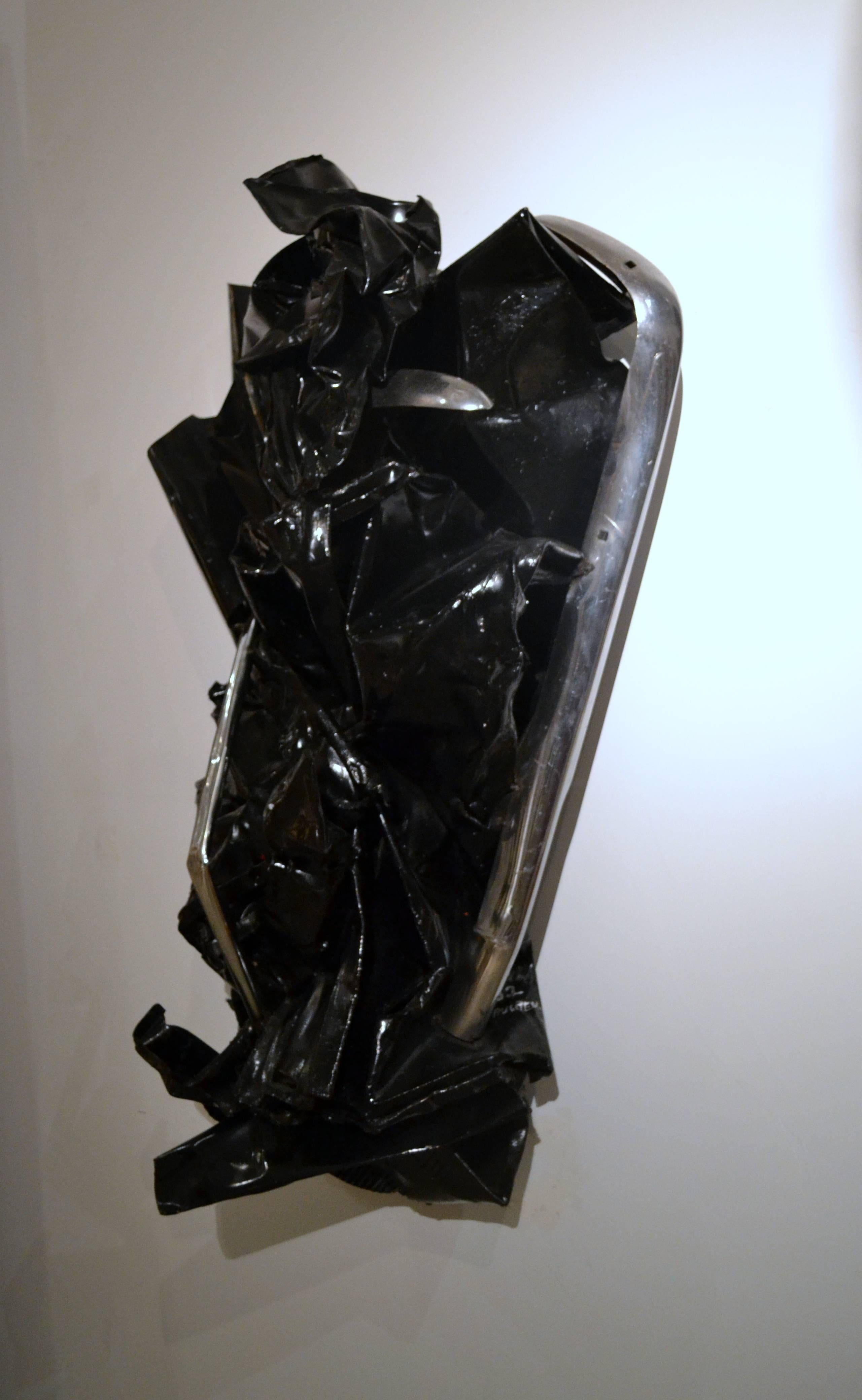 This abstract black steel and chrome sculpture by listed artist Paulden Evans (b. 1939) is aptly titled 