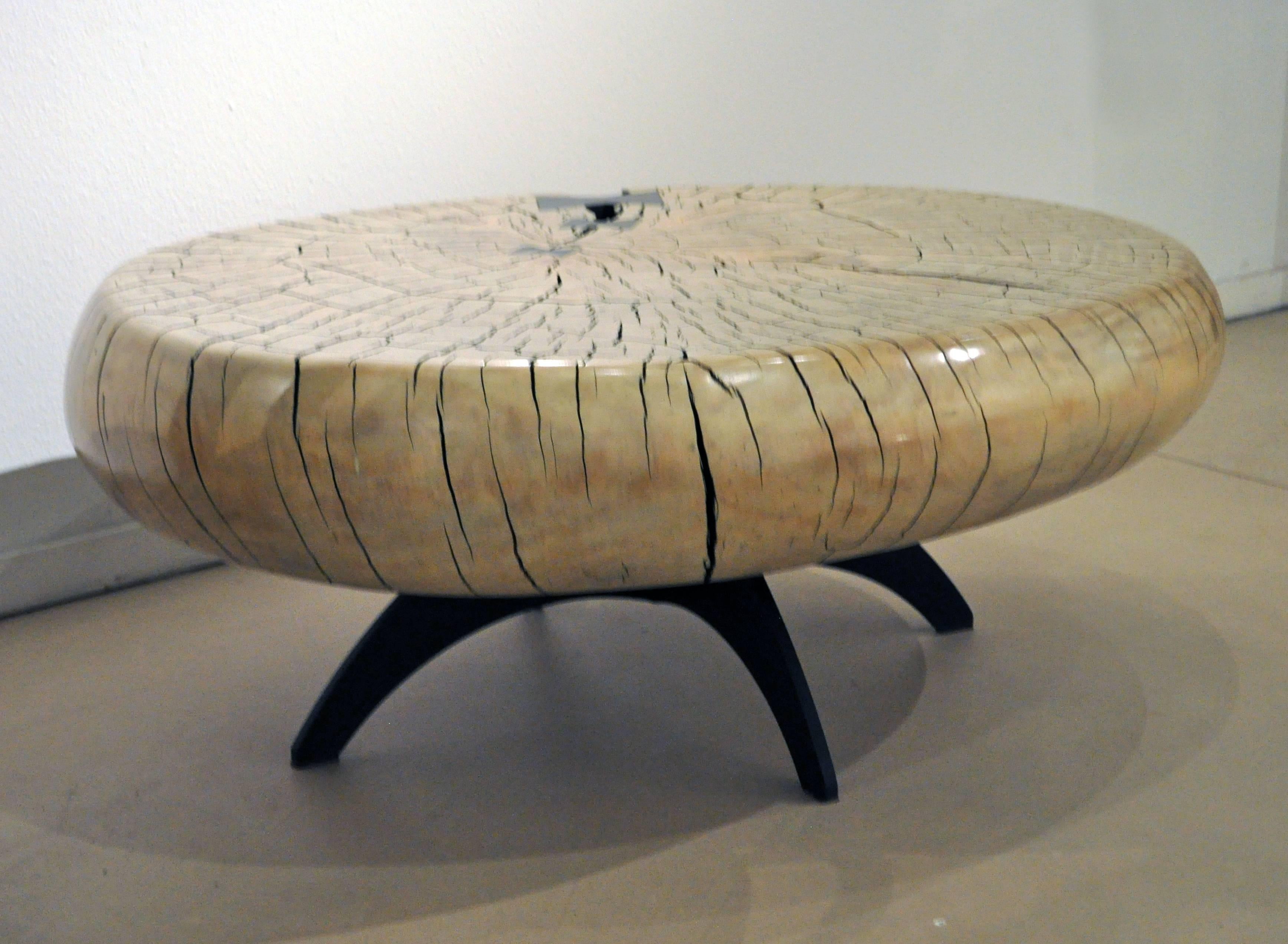 Artist Daniel Pollock, is well-known for his one of a kind sculptural tables and seats that he creates out of solid sections of tree trunks that he has salvaged from the San Bernardino National Forest. As an environmentally conscious artist, he