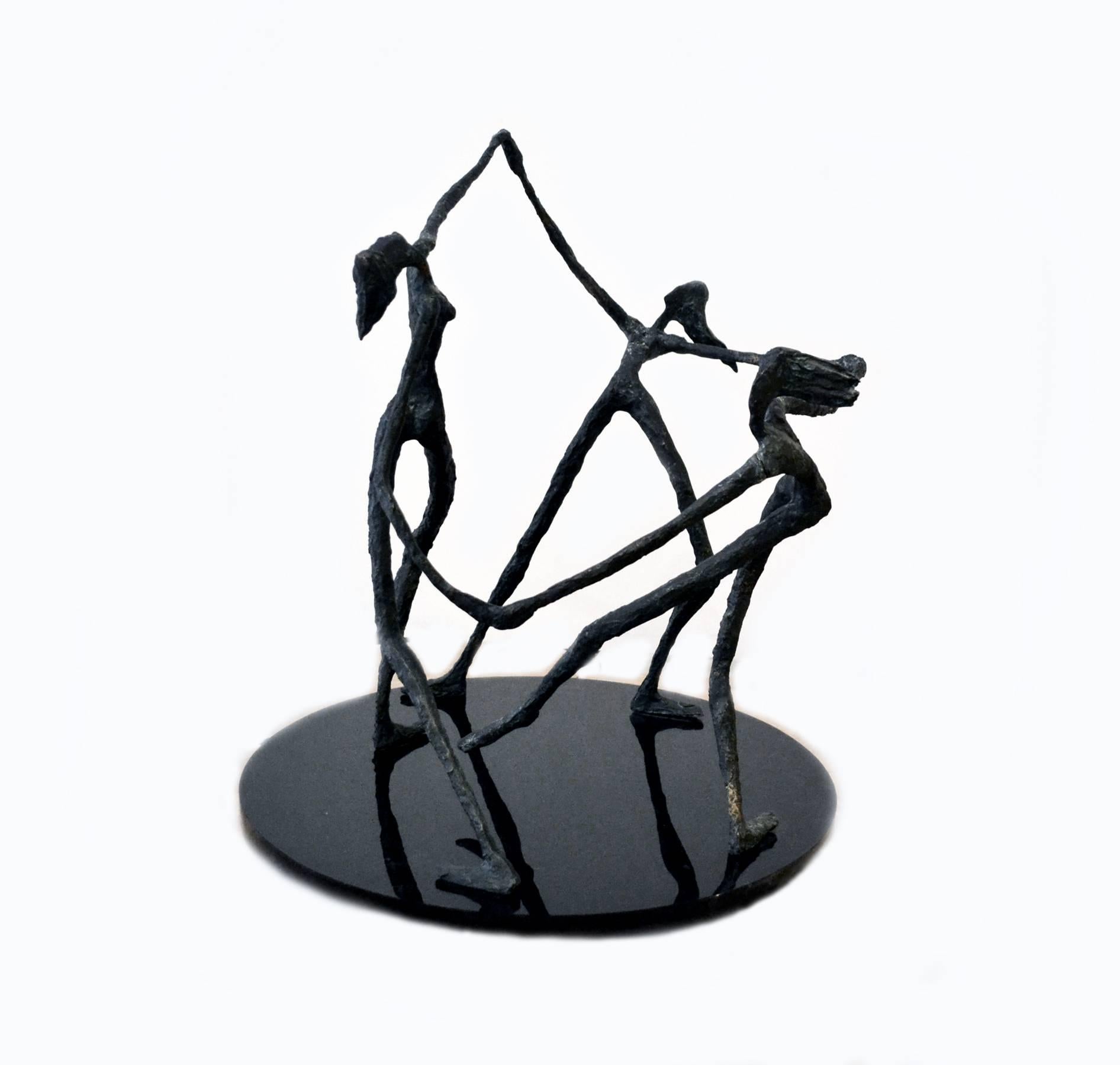 An exquisite vintage abstract bronze sculpture, circa 1940s-1950s, depicting three women dancing in a circle with arms joined, after renowned sculptor Alberto Giacometti. The bronze figures were forged with detail to movement, with hair blowing in