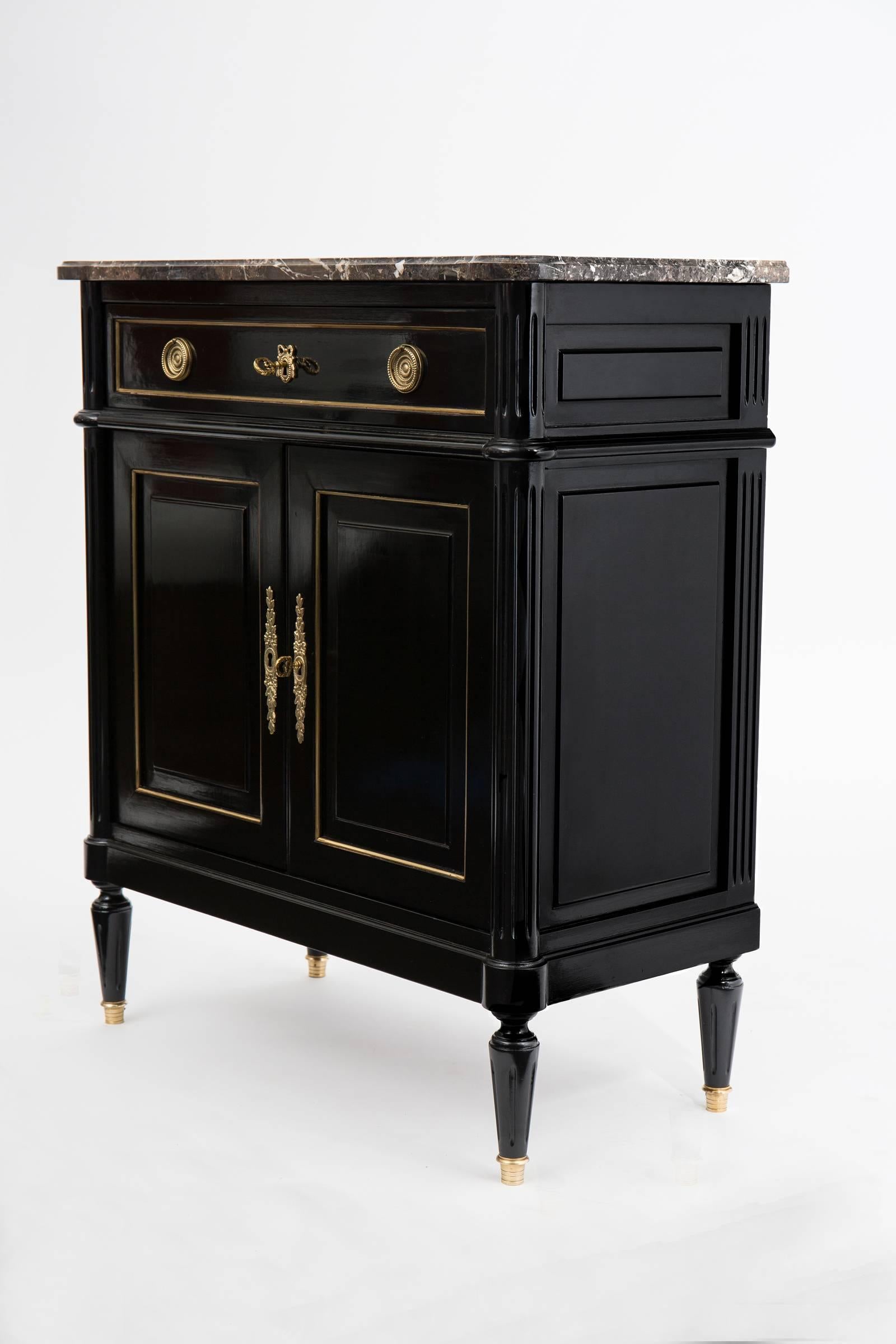 French antique solid mahogany buffet in the style of Louis XVI with a Brêche d'Alep brown and grey marble slab top. With its high quality construction, the gilt trim throughout and its finely cast decorative hardware, this charming buffet will take