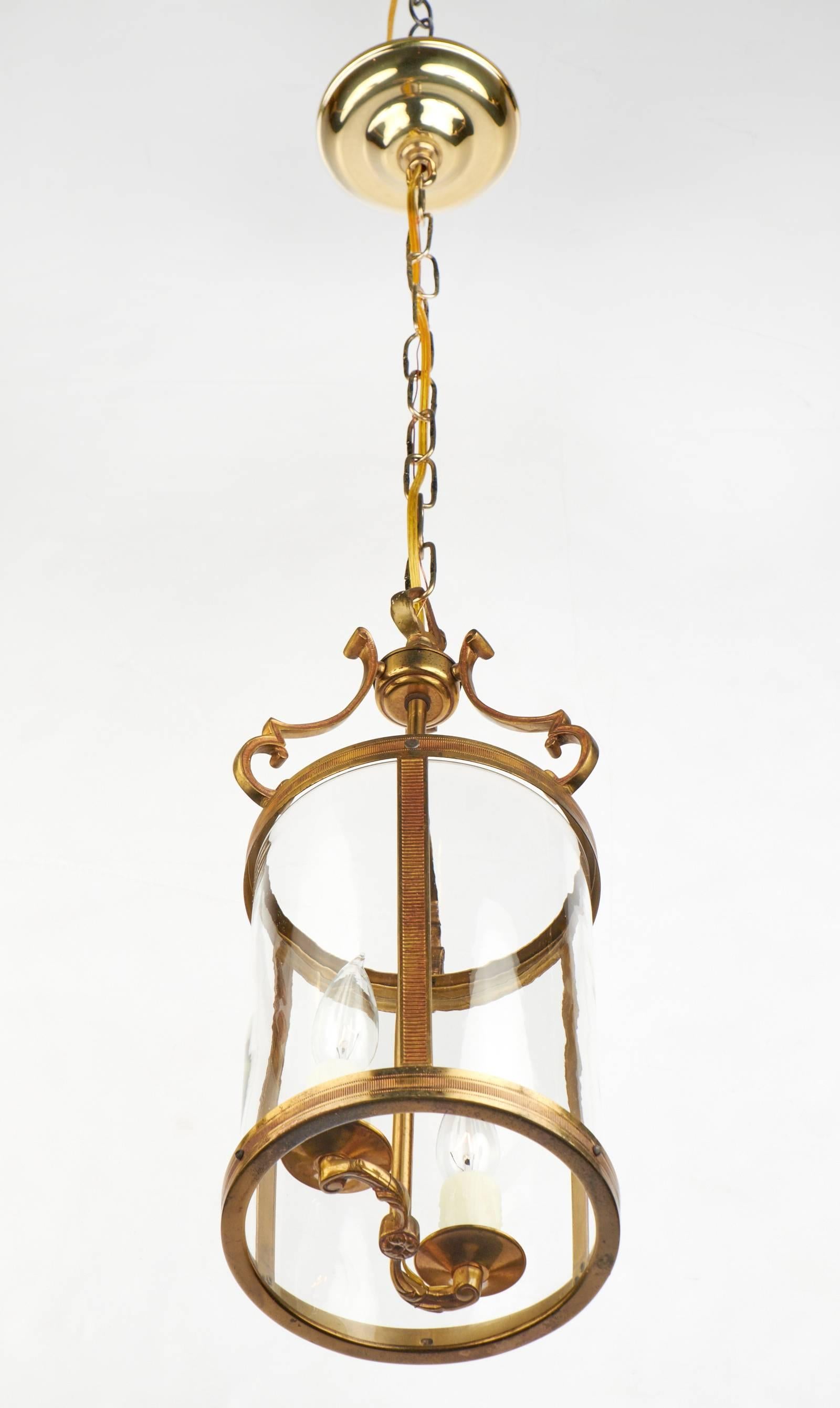 Bronze circa 1900 French lantern with rounded glass and finely cast cluster.

Diameter is taken at the brass rings, decorative arms extend slightly further. Height with included chain and canopy is 38.375 in.