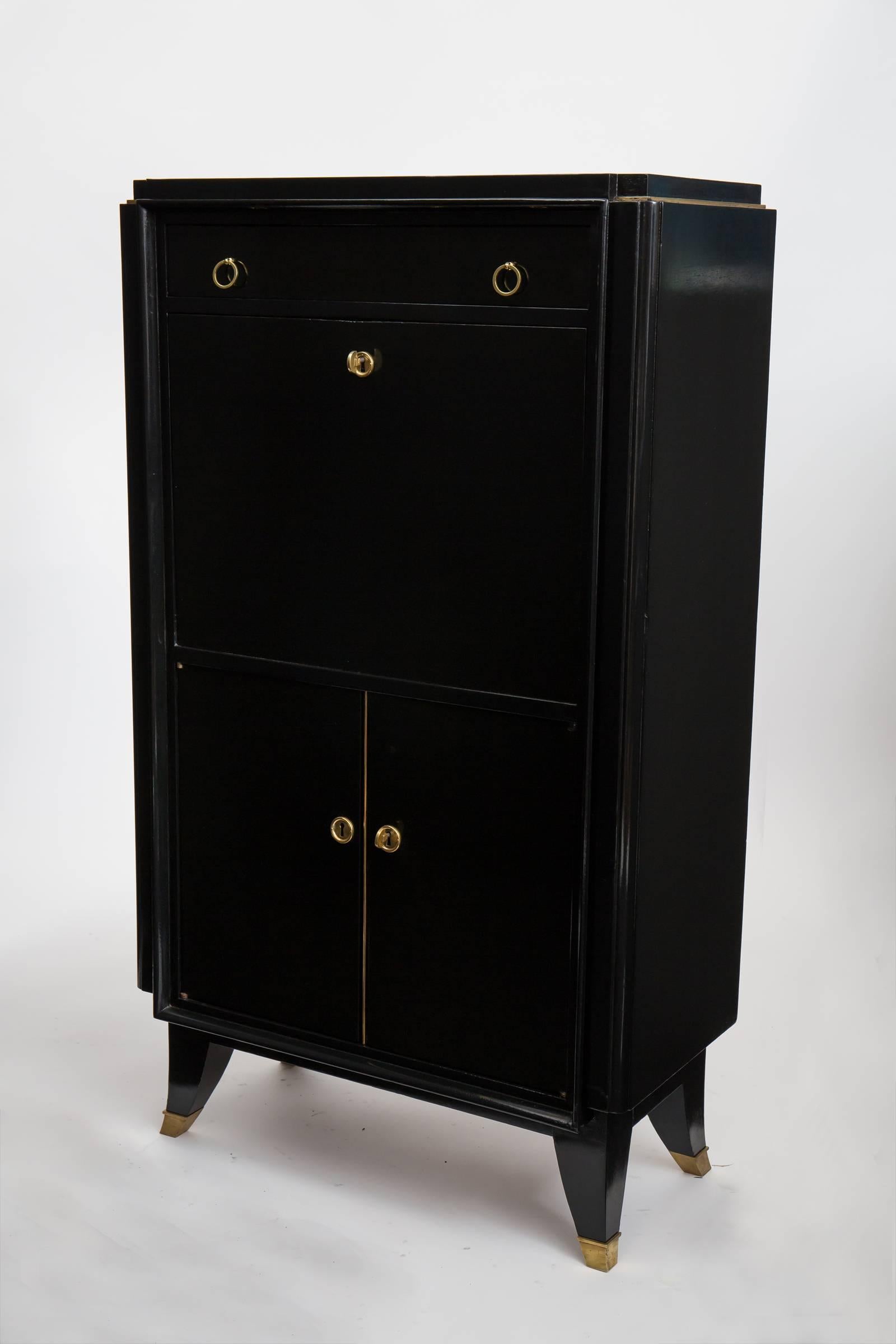 French Art Deco secretary of mahogany ebonized and French polished, a sleek piece with great lines, lemon wood interior, gilt brass details and an Argentinian leather top on the drop front.