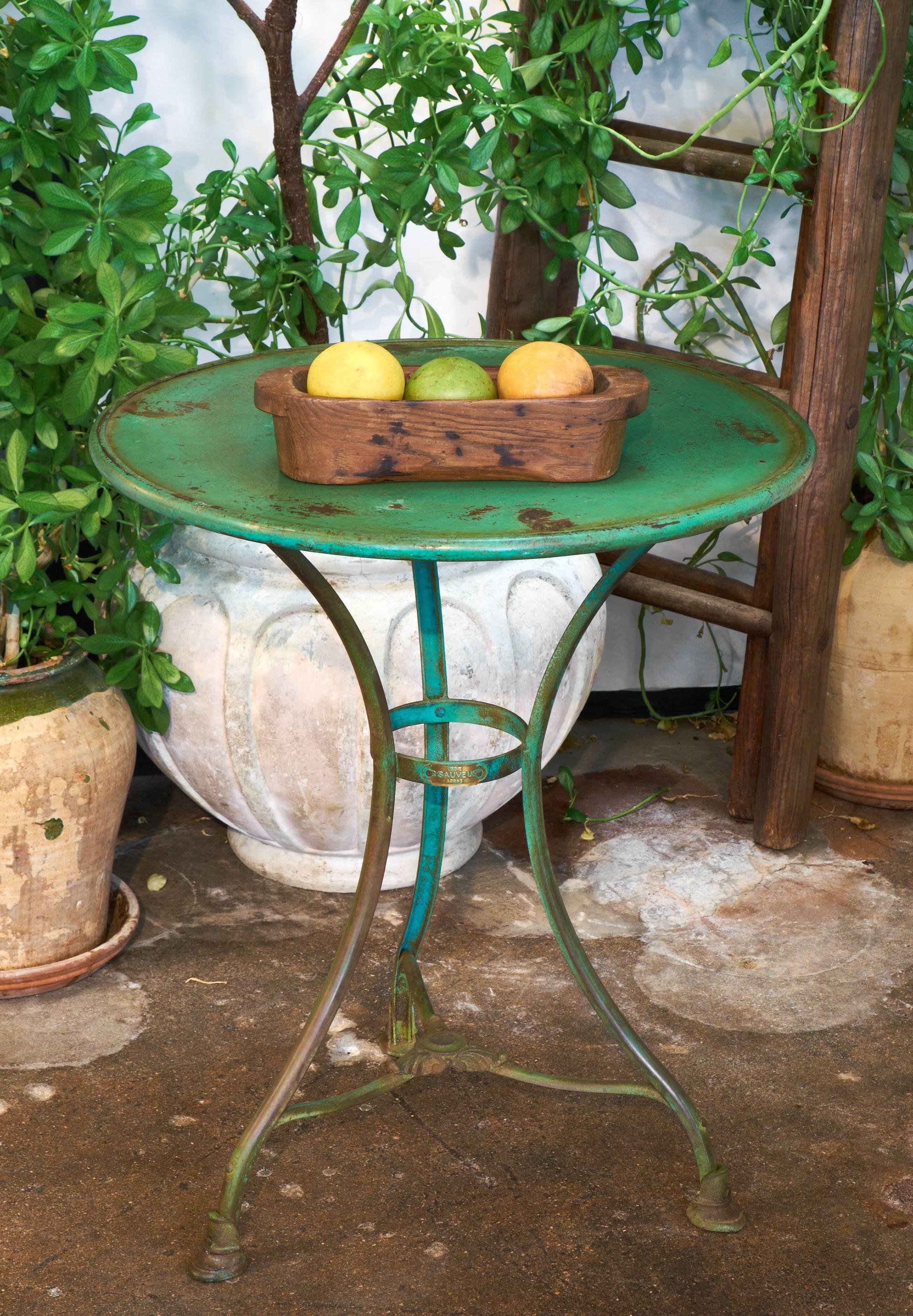 French antique cast iron bistro table by Usine St. Sauveur Arras with original brass stamp and fading green paint.