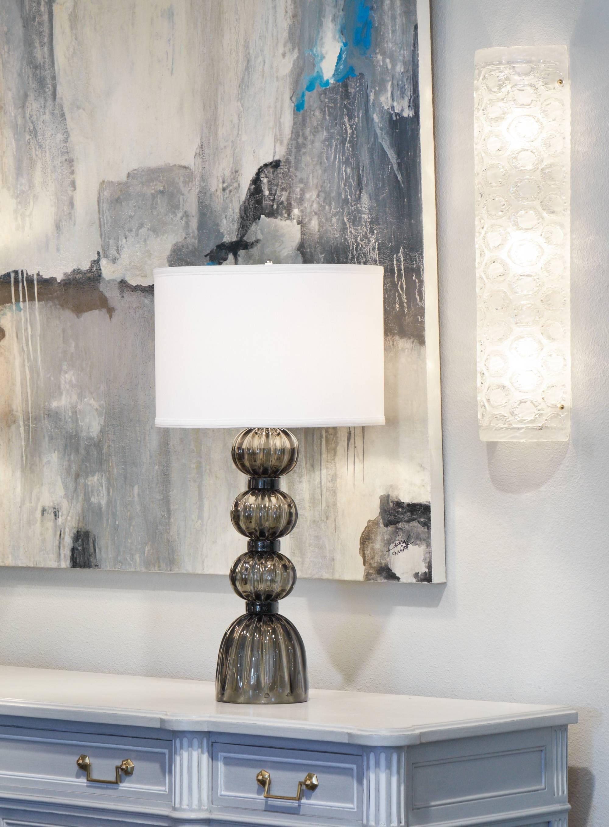 The thick luminous white stamped glass of this stunning pair of sconces will sparkle when lit or turned off. We couldn't resist their sophisticated pattern and clean 1960's glamorous design. Each sconce requires three medium-base bulb and is wired