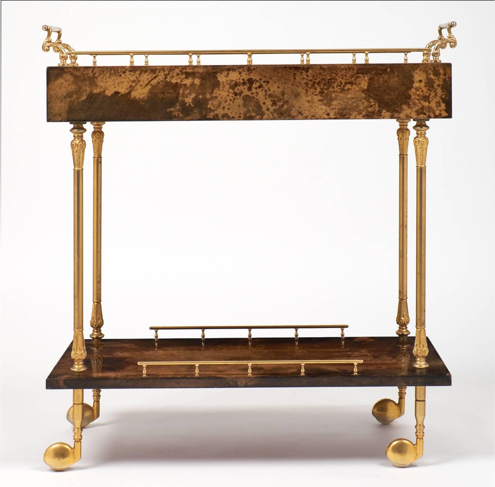 French vintage bar cart with two levels cased in lacquered goat skin with gilt brass handles and legs, on casters. A dovetailed drawer on each side will hold barware and serving supplies.