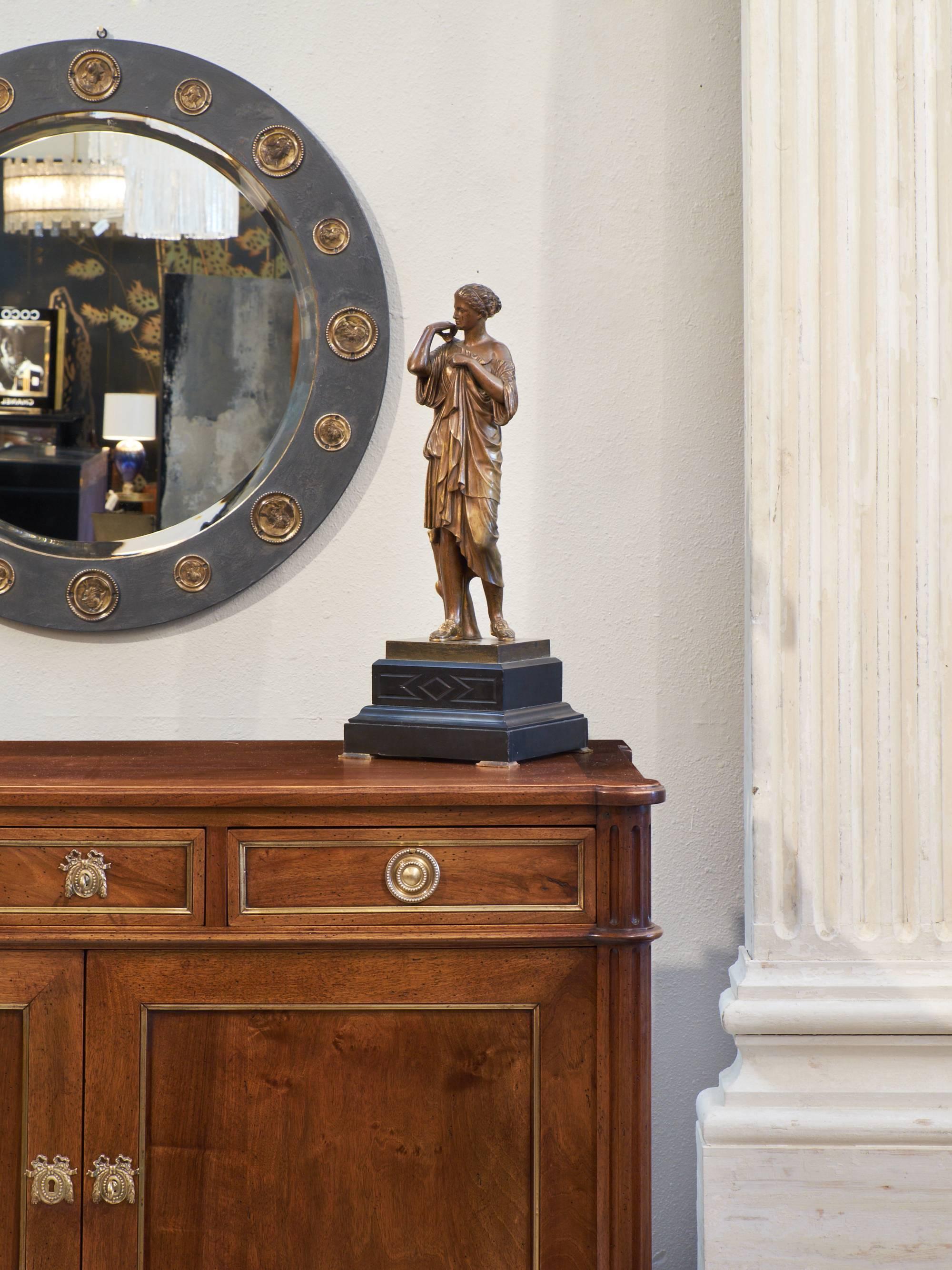 French antique bronze statue of an Athenian woman in a toga with beautiful detailing throughout, traces of gold leafing give the piece a beautiful glow, on a marble base with bronze feet.
