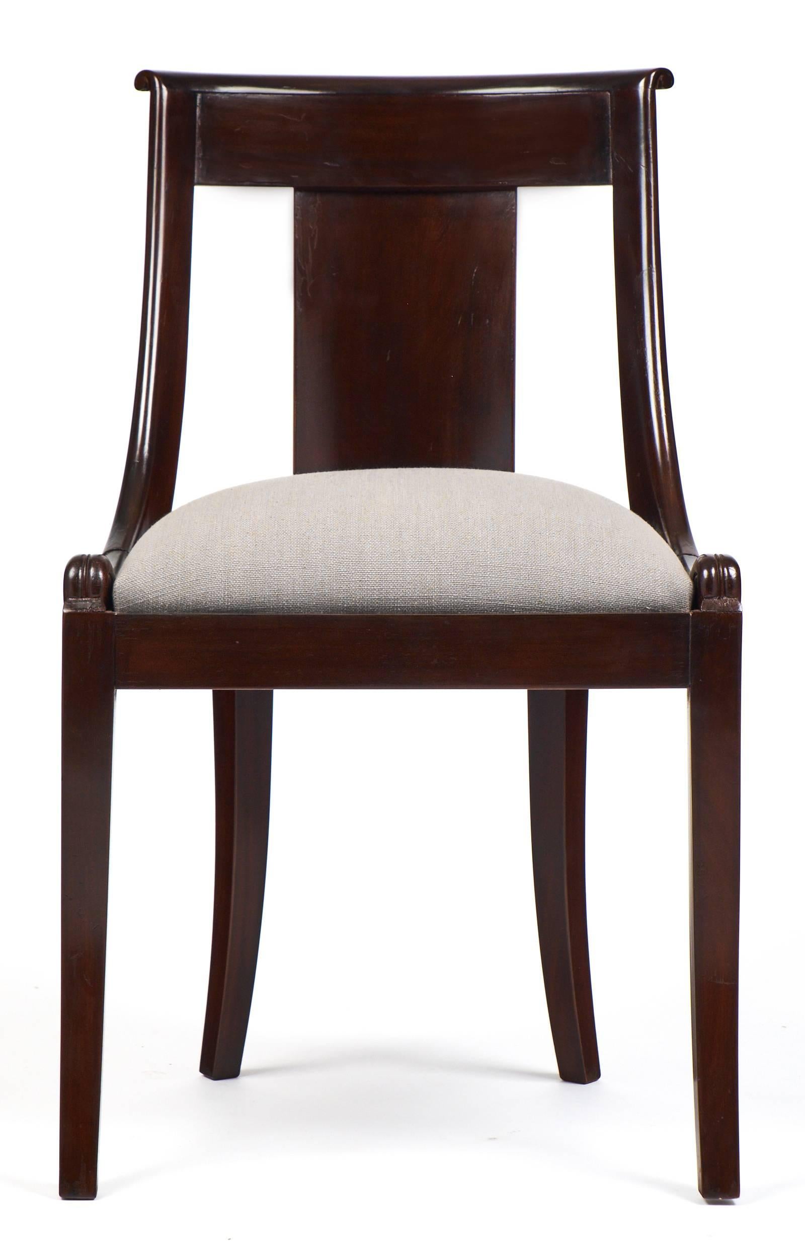 French antique set of ten Empire style gondola chairs of solid mahogany with a lustrous French polish finish. Beautifully carved with a comfortable, curving back. Professionally reupholstered in a gray linen blend. Graceful lines with sturdy
