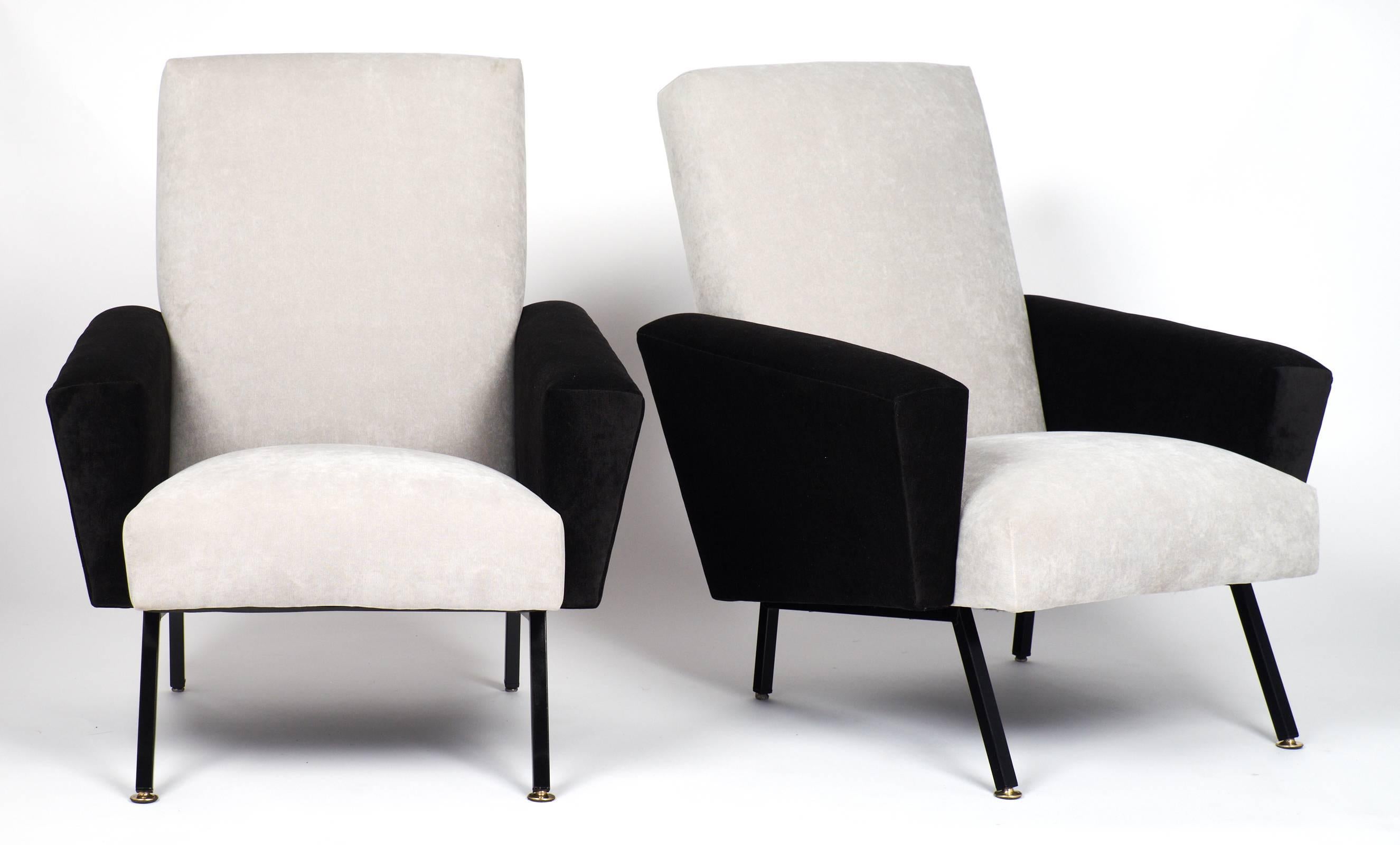 French modernist period pair of armchairs. Professionally reupholstered in light gray and black velvet with black lacquered steel legs, brass feet. A stylish, comfortable pair for your loft, living room with a strong Pierre Guariche influence.