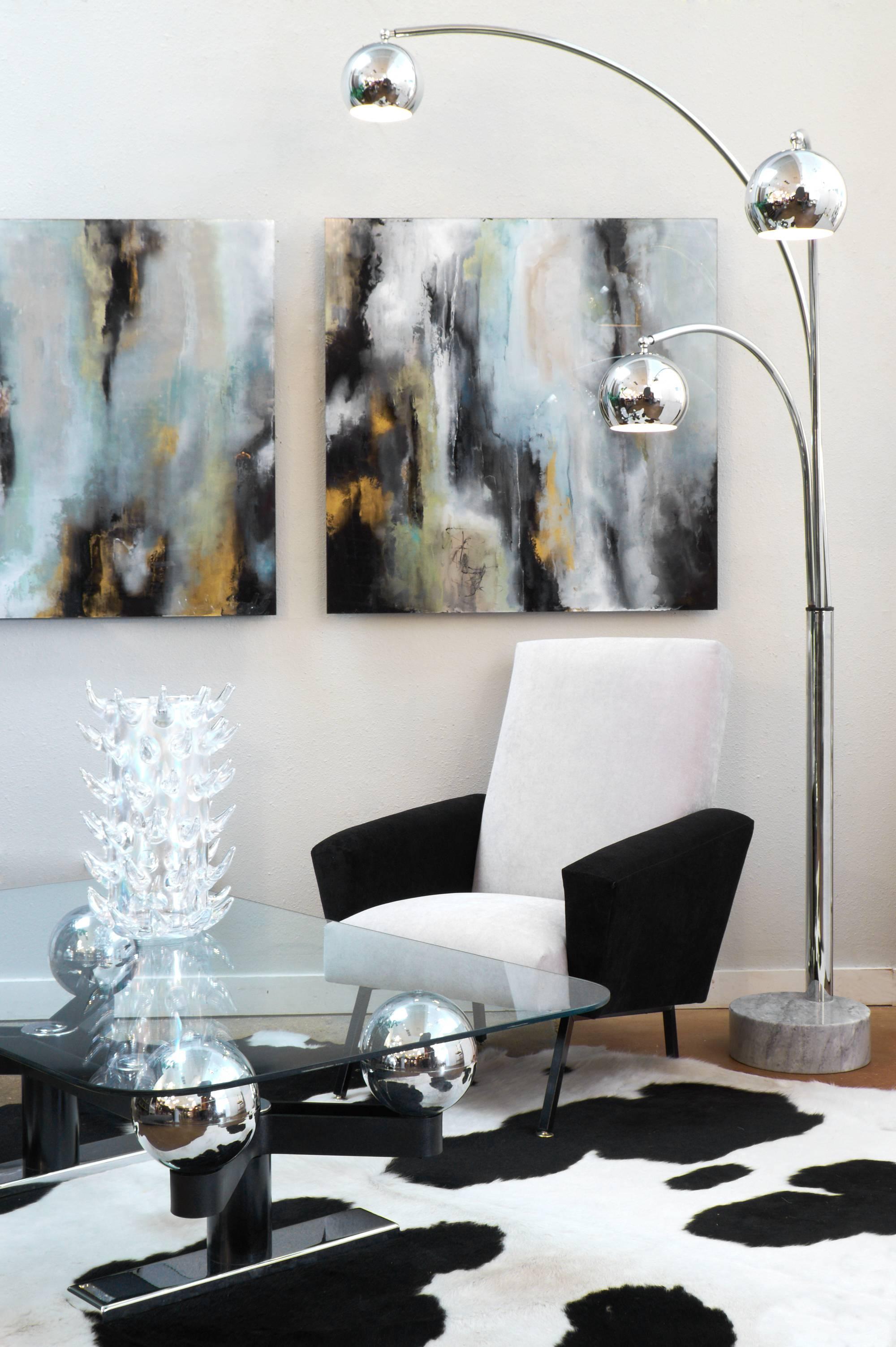 Italian vintage Mid-Century Modern period chrome floor lamp with three arcing, independently adjustable arms. Each chrome shade is also adjustable up and down. Thick carrara marble base is 11 7/8