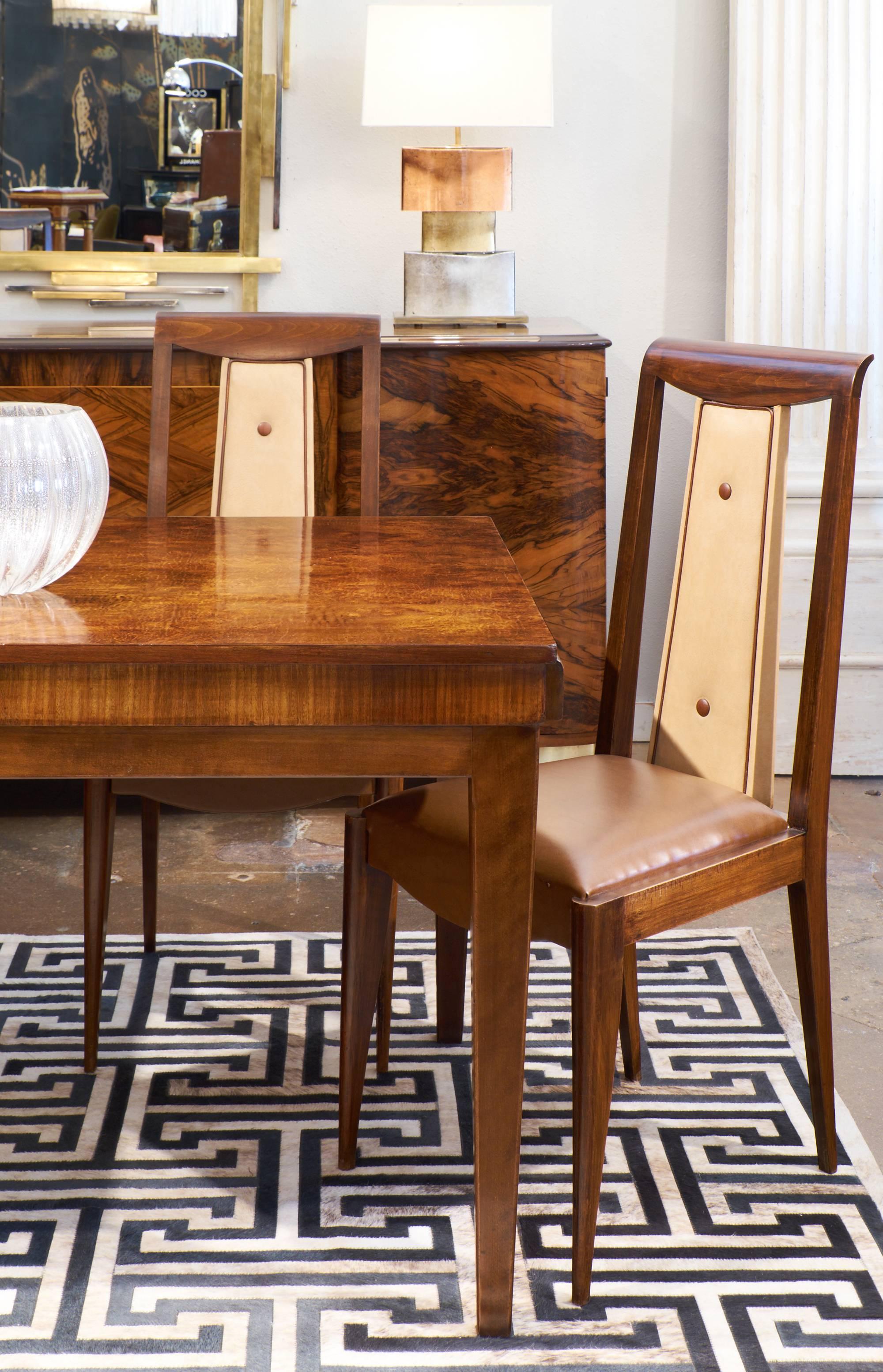 French Art Deco period set of six dining room side chairs. Solid walnut with a French polish finish and original upholstery. We love the tuxedo look to these with piping and buttons on the tall, lean backs. We can reupholster with fabrics of your