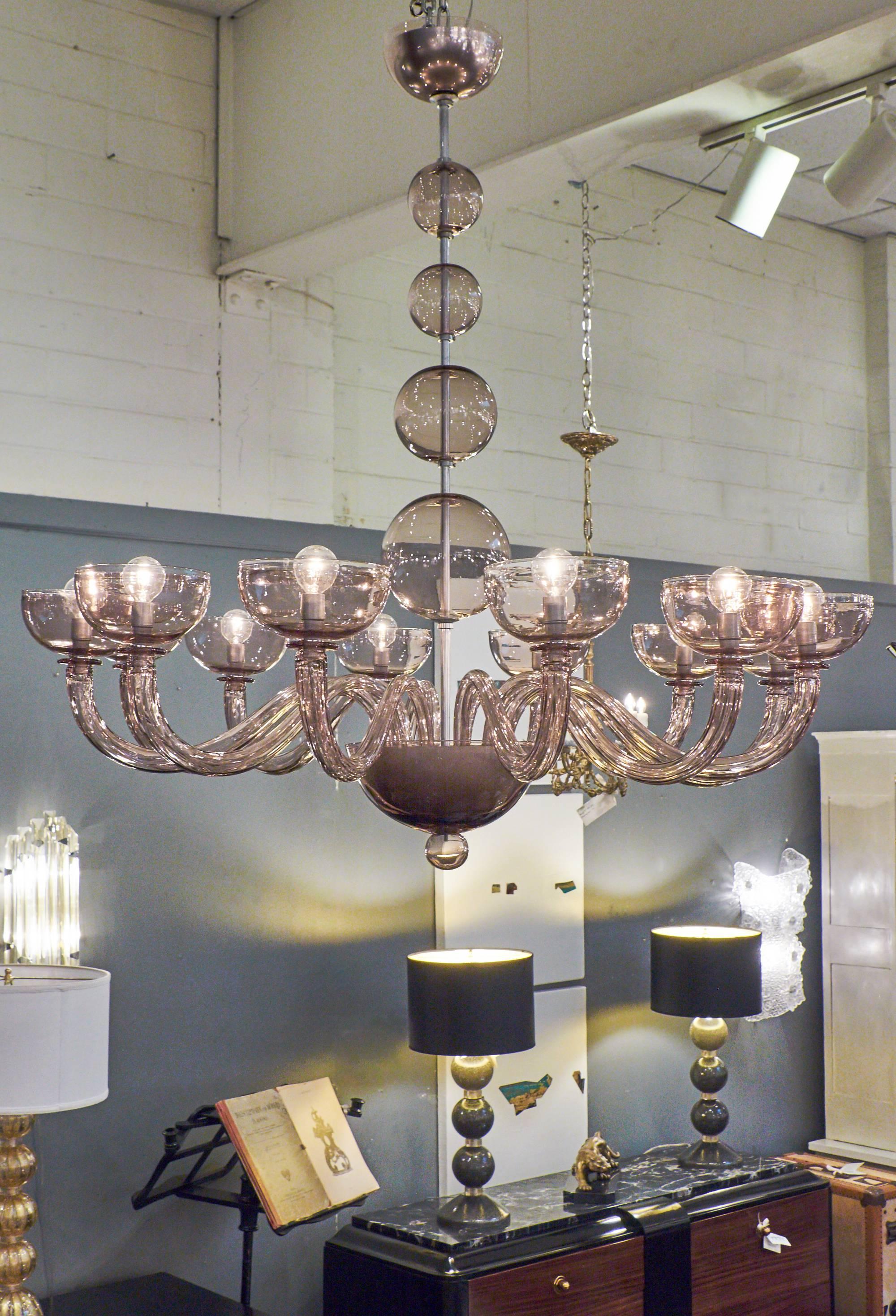 Italian Murano amethyst glass chandelier with 12 branches, rewired for the US. Very clean design with smooth glass of the highest quality.

This fixture is currently located at our dealer's warehouse in Italy. Please contact us for a lead time. 
